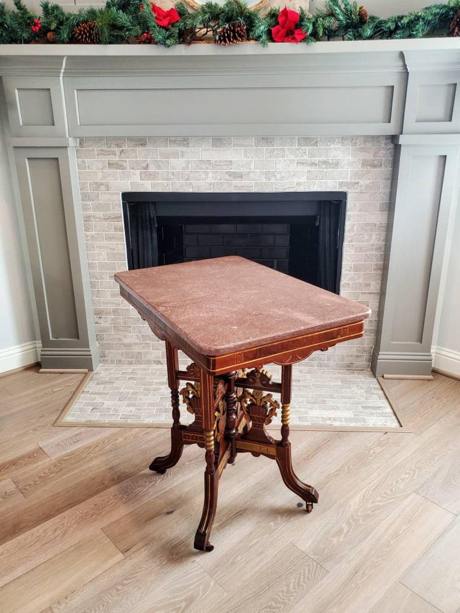 A superb example of Victorian splendor and its attributes, elegant, sophisticated, refined American high style, this richly decorated parlor (center) table features the original substantial rouge marble stone slab top with molded edge, over a solid