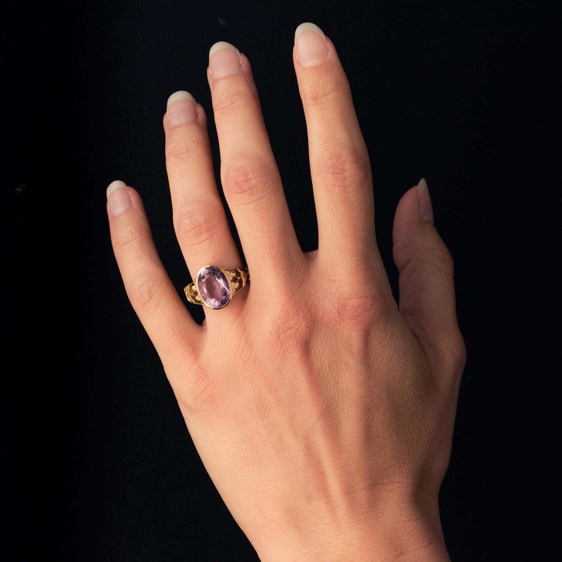 Ring in 18 karat yellow gold.
This antique ring is adorned on its top with a bezel-set amethyst, supported by openwork plant motifs on the start of the ring.
Height : 13.8 mm, Width : 10.5 mm, Thickness : 5.8 mm, Ring Width at Base: 2.7 mm.
Total