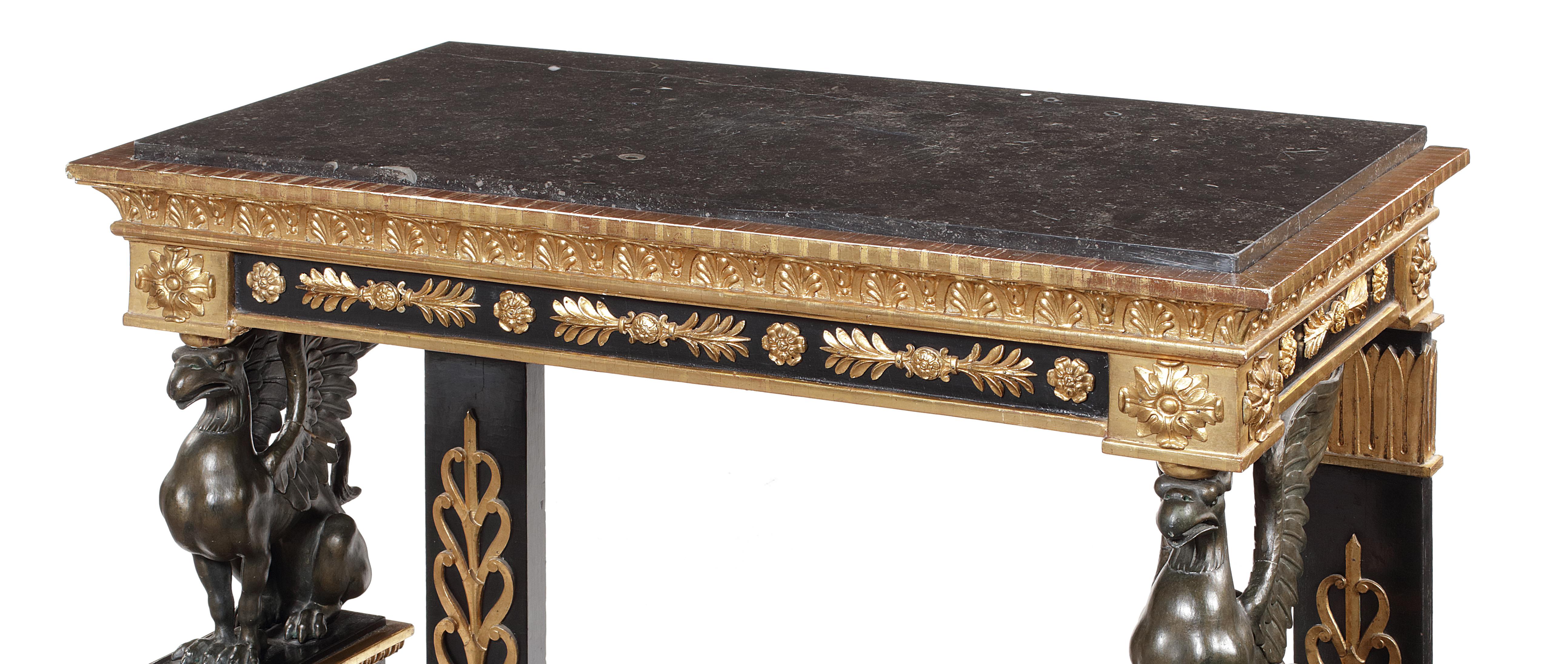 19th century and later, ebonised, gilt wood and composition console table
in the Empire style, after Percier & Fontaine
The rectangular inset black fossilised marble top above anthemion and thrysus applied frieze, on griffin supports applied with