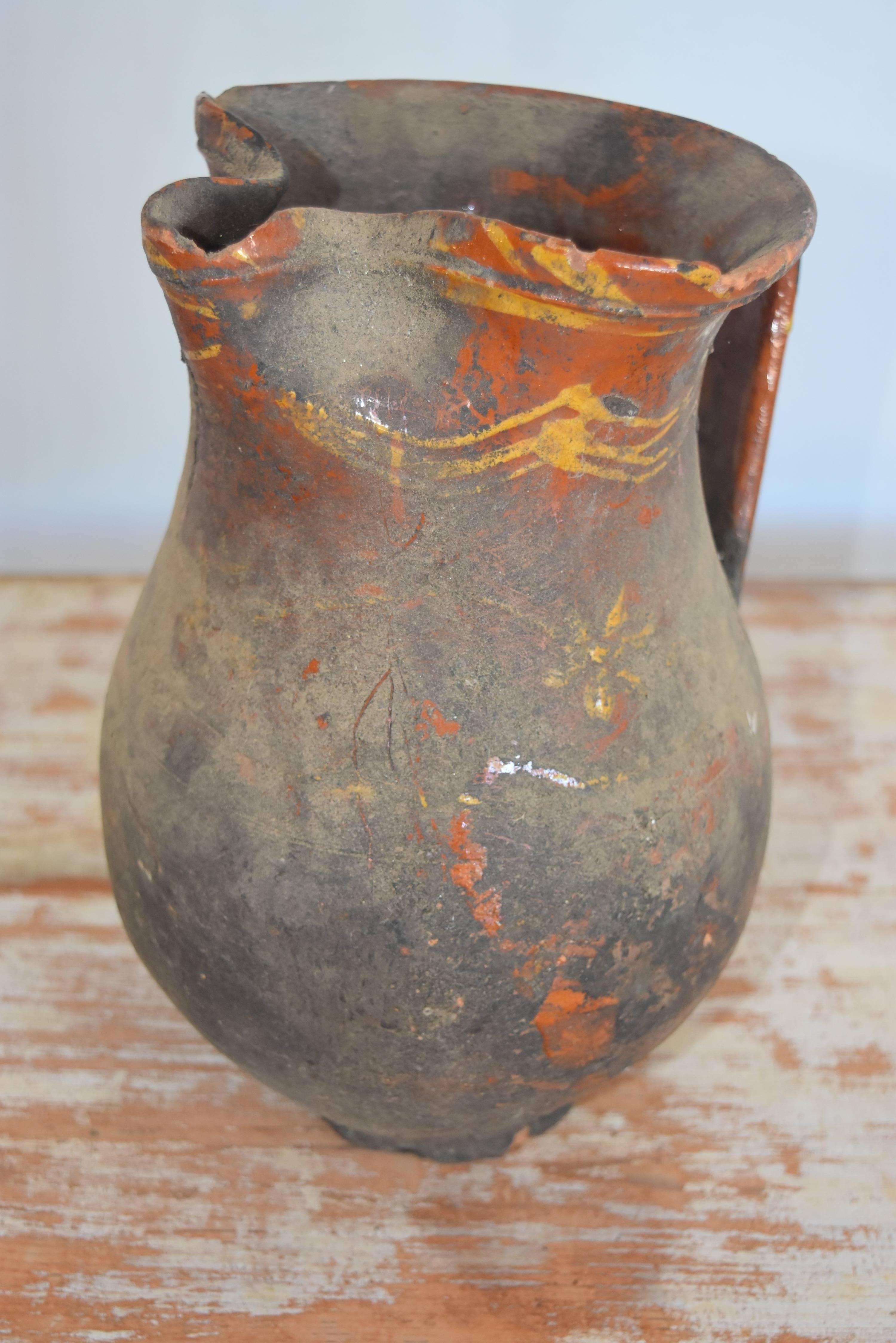 This is a nice larger scale Spanish pitcher from the Andalusia region of Spain. It has lots of great character in the old patina as well. It has tiny chips around the top but in great condition otherwise.