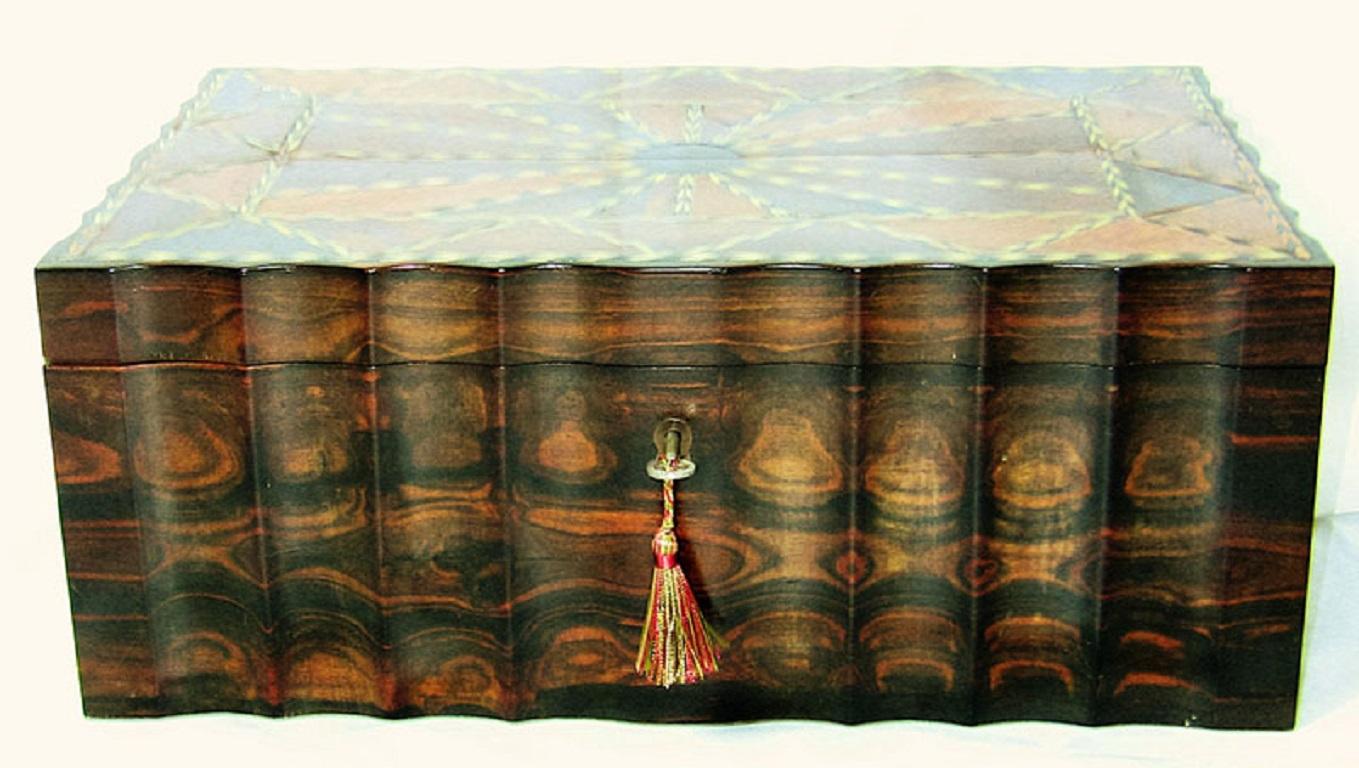 Absolutely stunning 19th century Anglo-Indian (or more accurately, Anglo-Ceylonese) box.

Made of rare and expensive Coromandel wood and inlaid on top with specimen exotic Asian woods, pewter, silver and bone.

The interior of the lid is likewise
