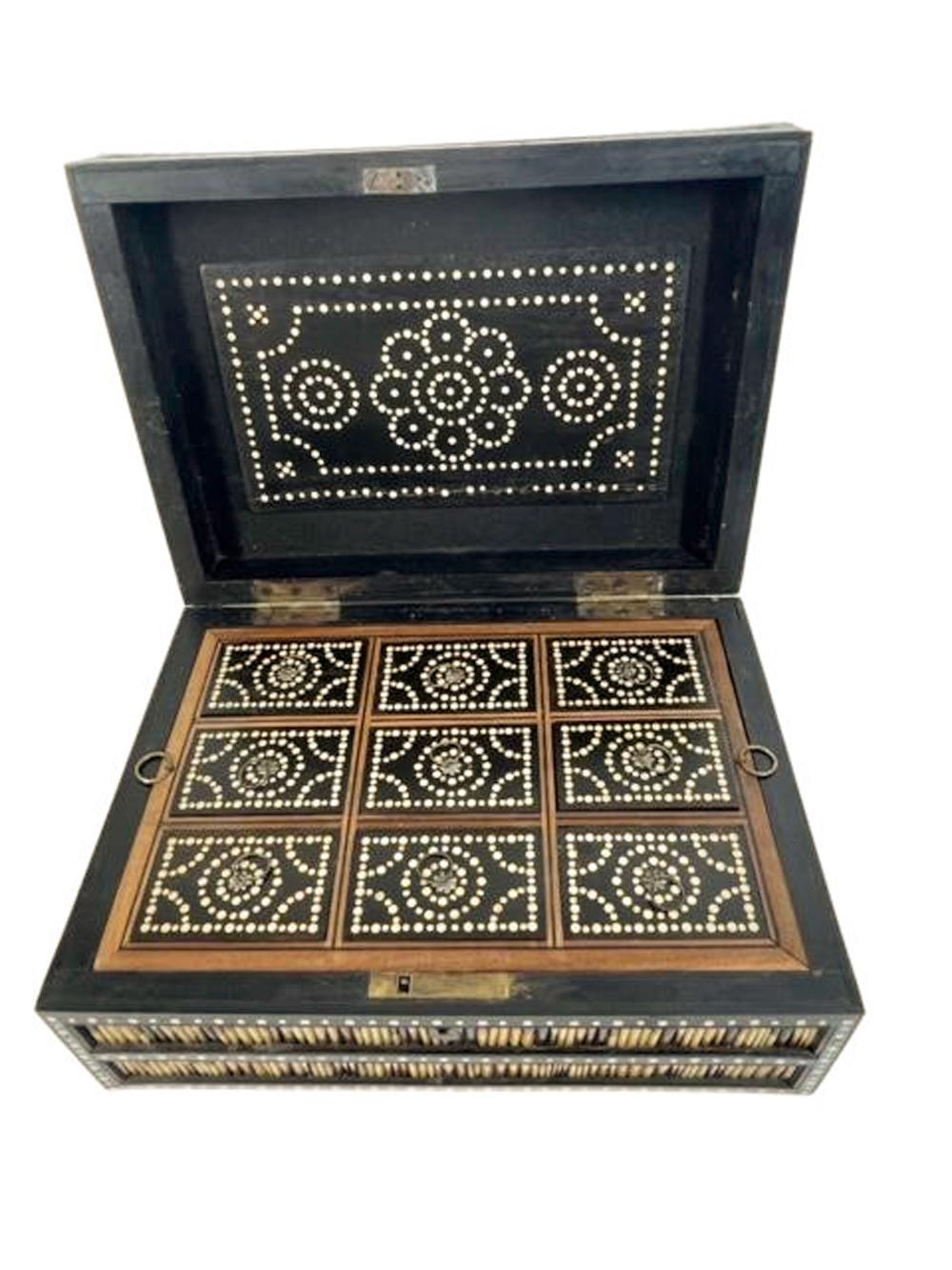 A large rectangular box made of dark hardwood inlaid with bone dots framing panels of porcupine quill. The exterior of the box is veneered with quill cut and arranged to create a zig-zag pattern using the light and dark areas of the quills. The