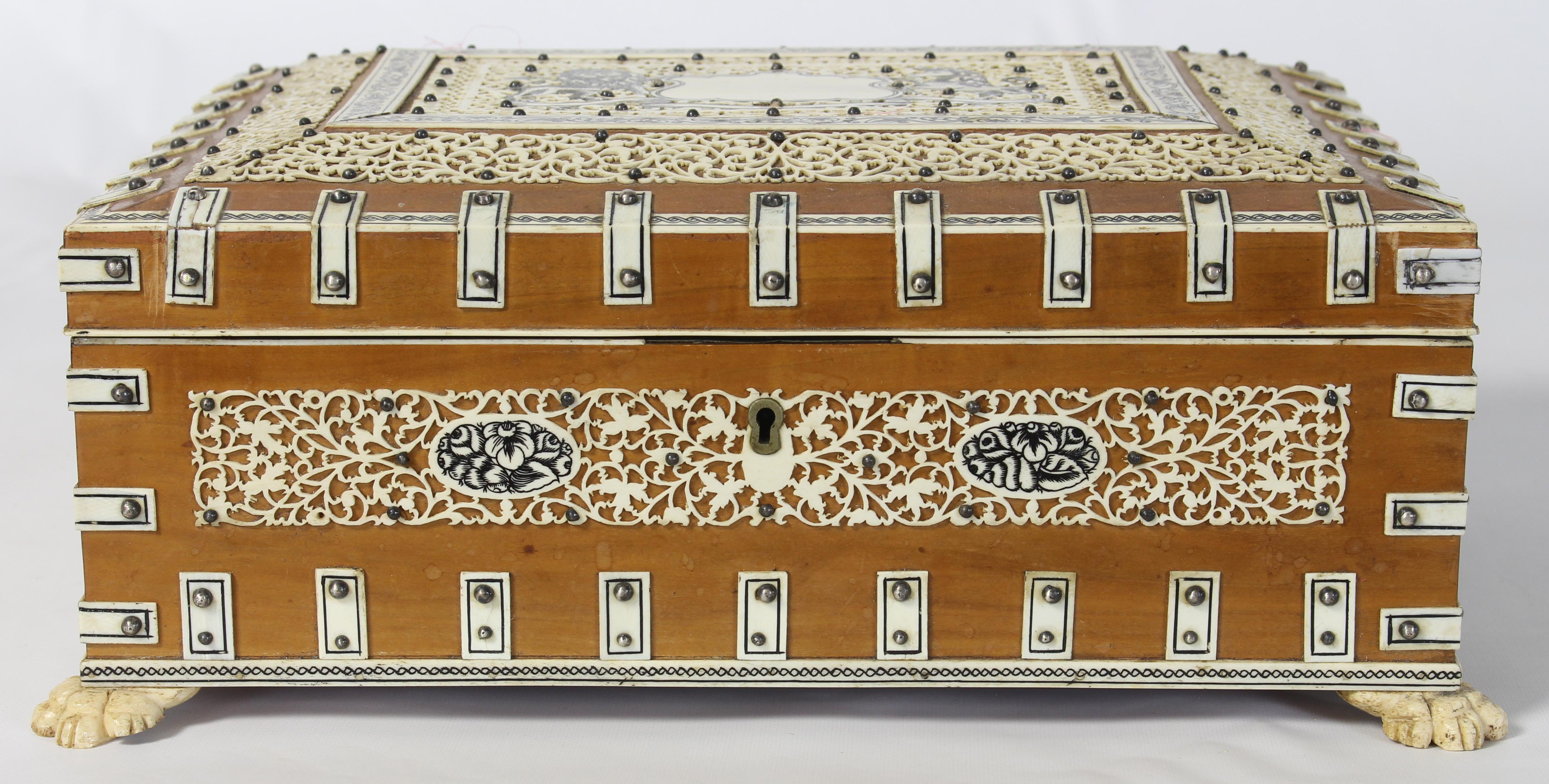 A late 19th century Anglo-Indian footed box made of sandlewood and bone engraved with the English Lion and Unicorn flanking an un-engraved cartouche.