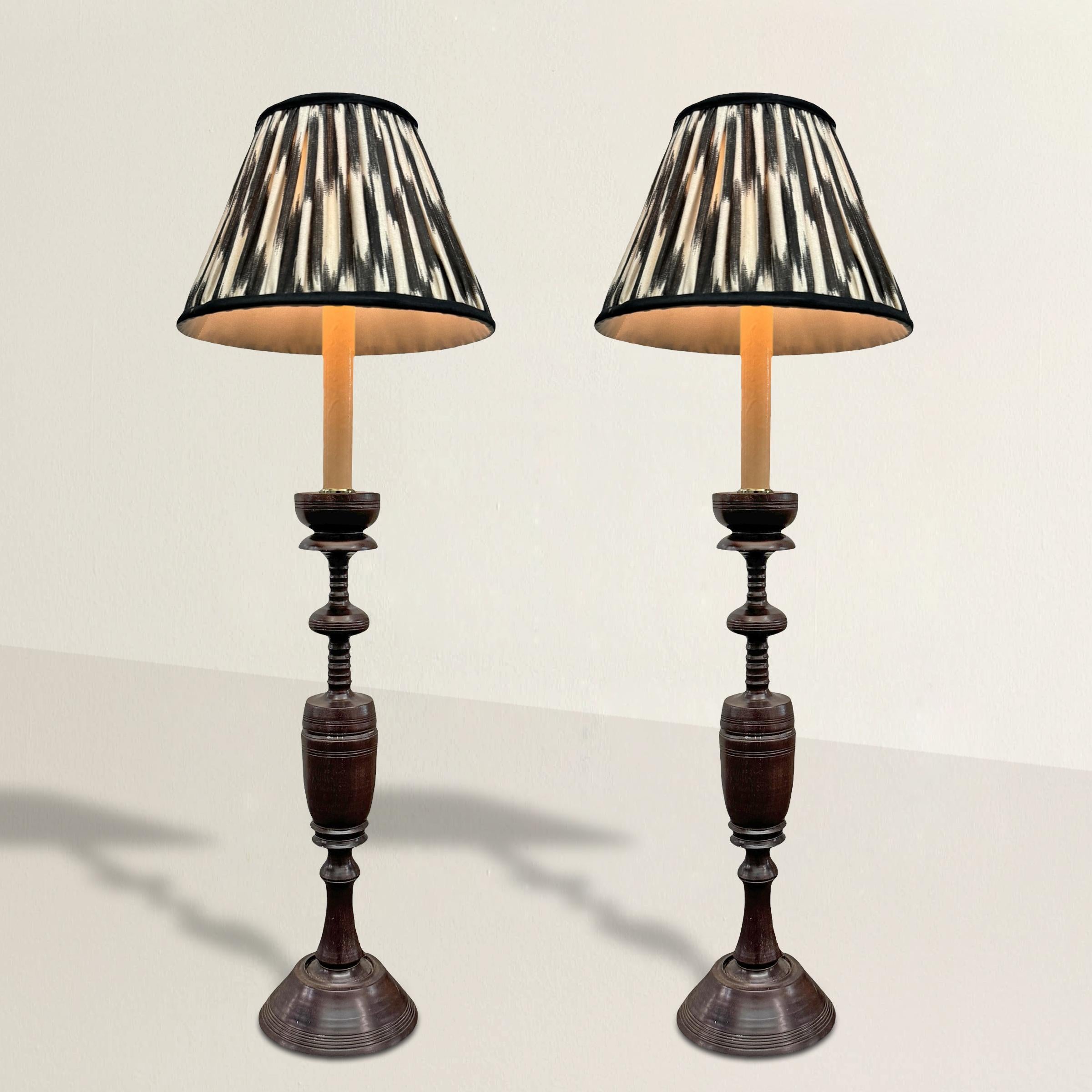 This stunning pair of 19th-century Anglo-Indian rosewood candlesticks showcases exquisite craftsmanship with beautifully turned central urns and intricate beaded detailing. Rich in history and character, these candlesticks have been newly