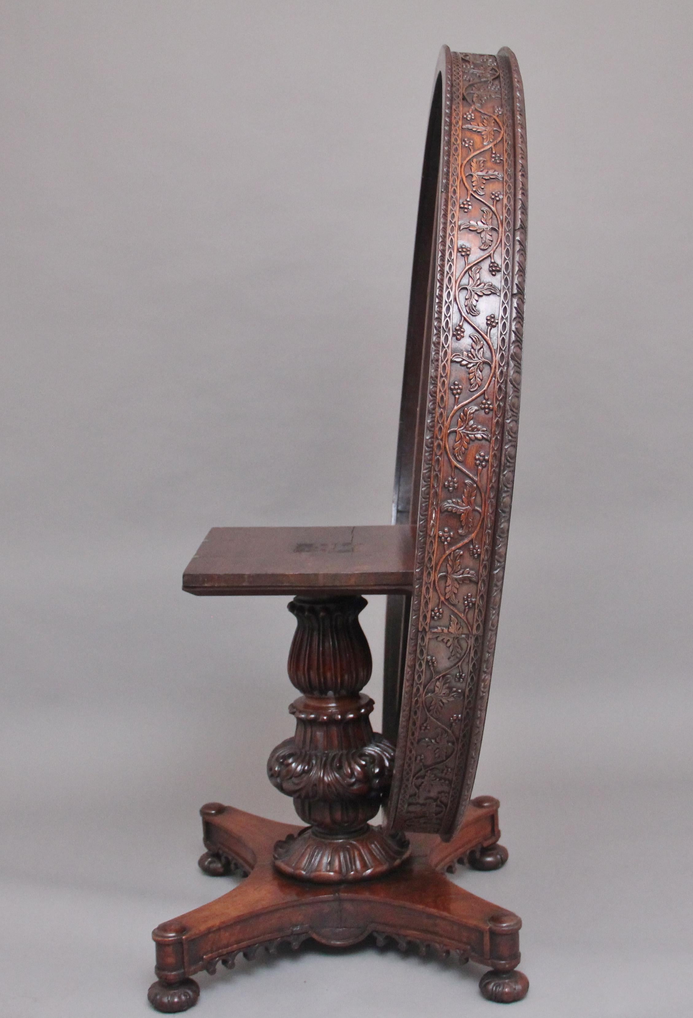 A rare mid 19th century Anglo Indian colonial carved teak tilt top centre table, having a lovely figured top with a deep carved frieze consisting of vines and berry’s, the top supported on a heavily carved tulip shaped column terminating on a shaped