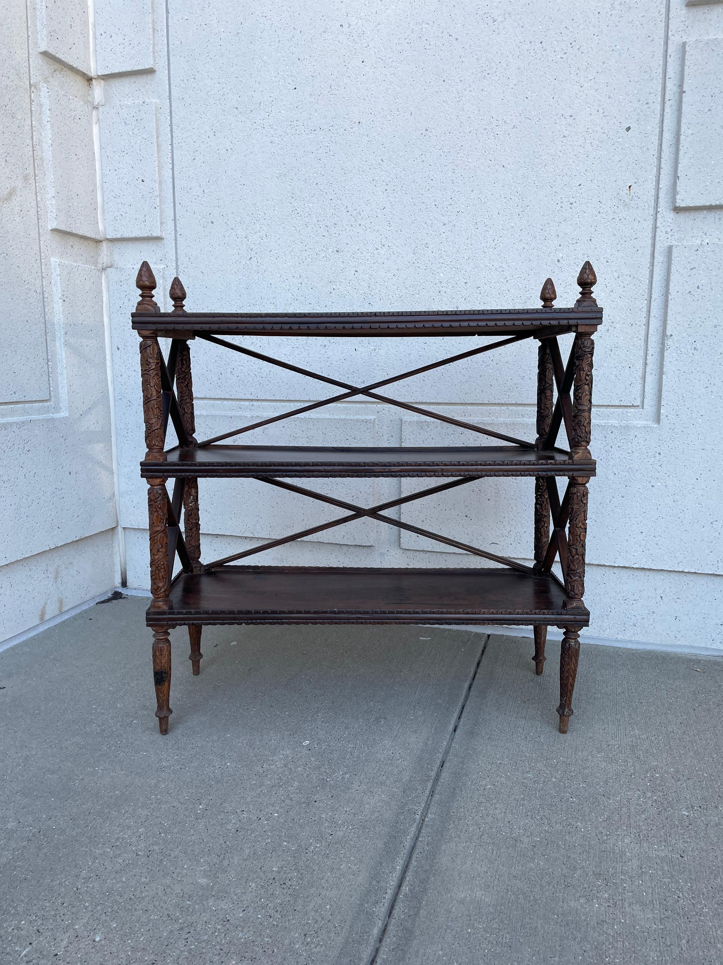 19th century Anglo Indian hardwood three level server or shelf with pine cone finials. The shelves with galleries supported by hand carved posts with floral decoration. This makes a great buffet for serving, or an unique shelf with lots of character