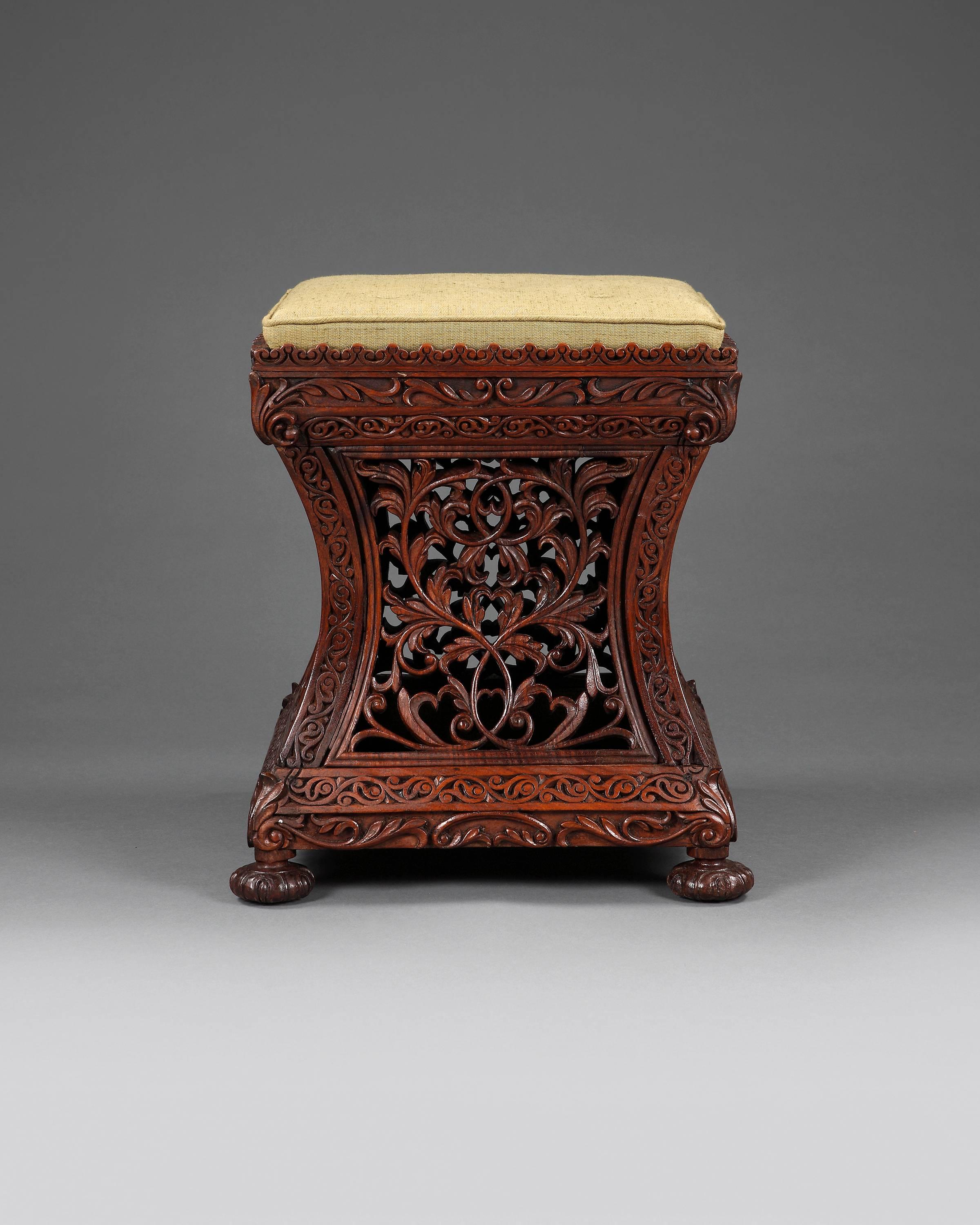 A finely carved and stylish blackwood stool with upholstered drop in seat. Having concave sides and supported on small carved squat feet.
The common name for this blackwood is rosewood.