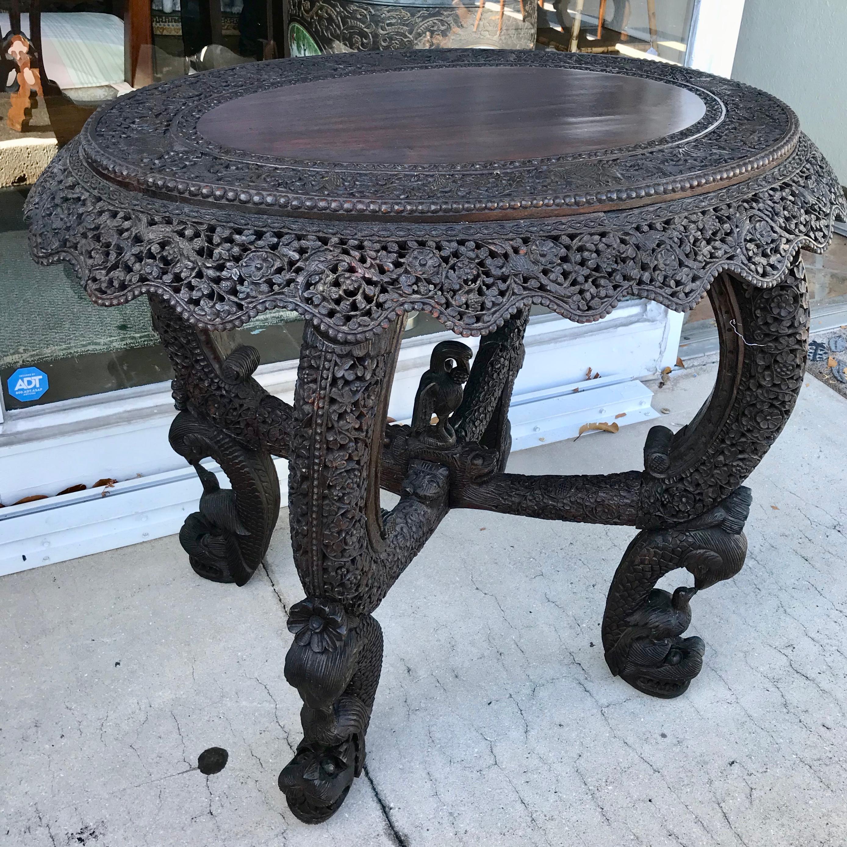 The table is profusely carved with depictions of animals and birds.
Exquisite hand wood carving with beautiful scale and patina.