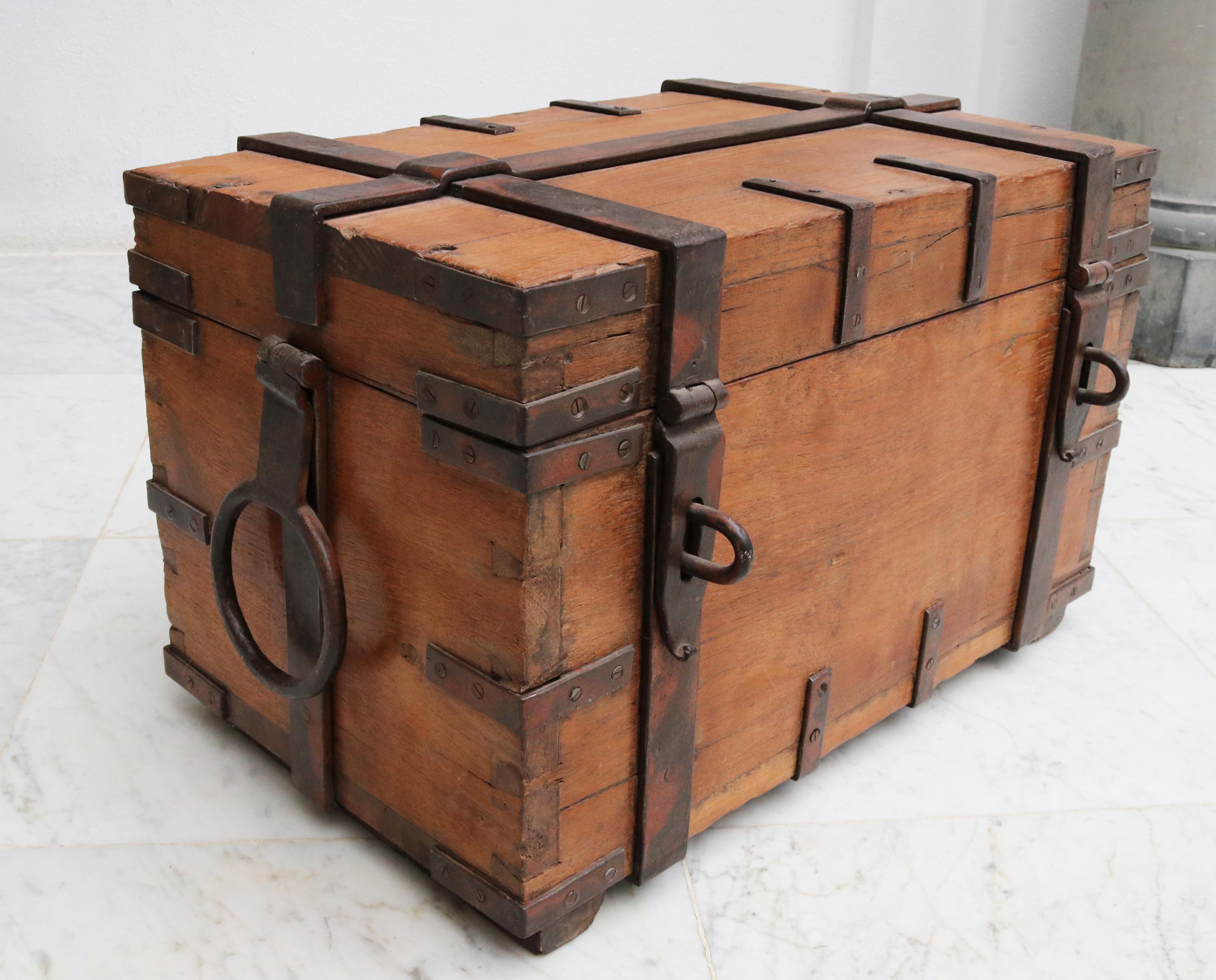 19th century Anglo-Indian colonial fruit wood chest with wrought iron fittings. 

Robust chest with iron fittings on all sides, rounded handles on the sides and two locks on the front for padlock.