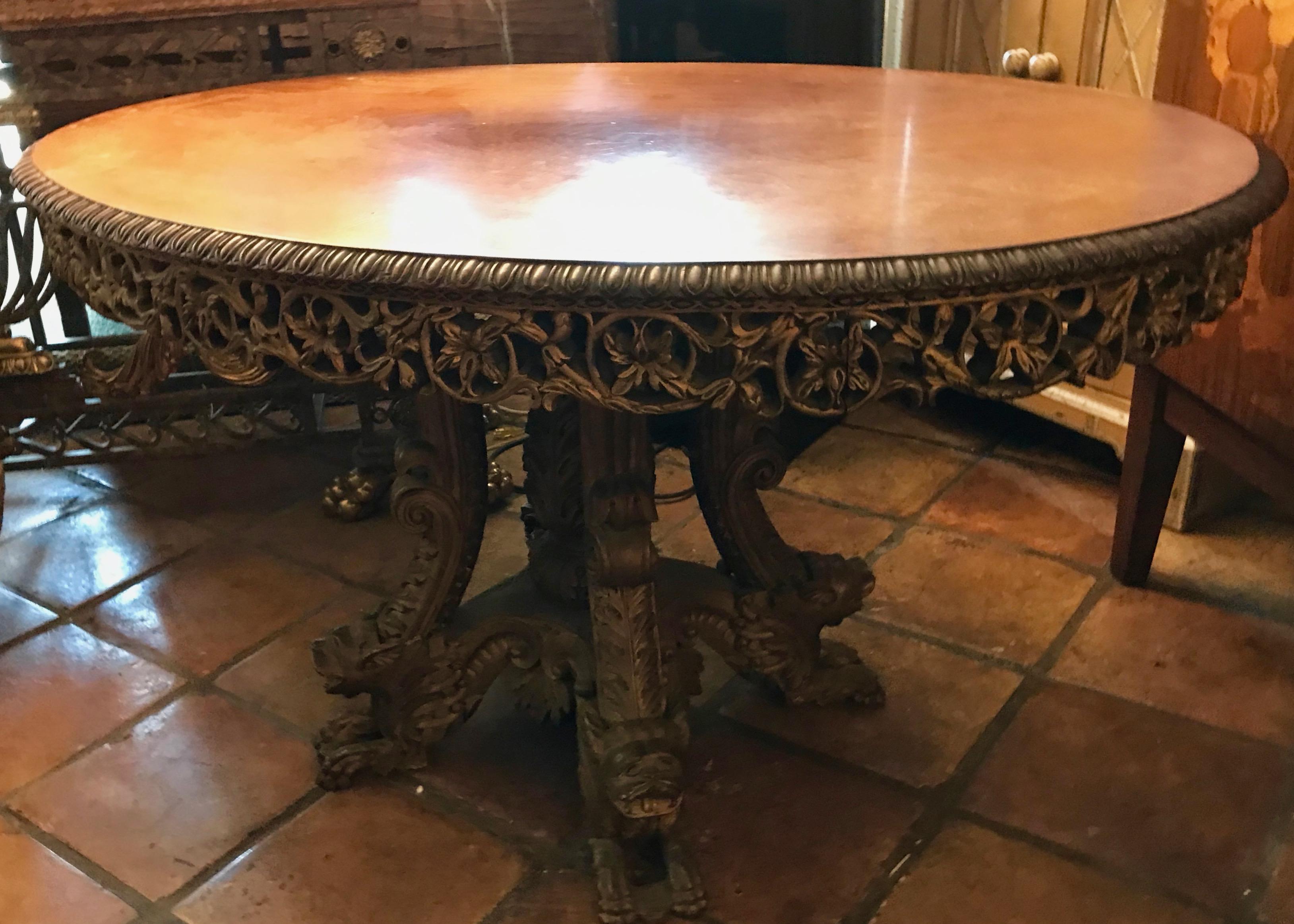 Beautiful scale and form ( oval ). 
The table is fashioned with an elaborate pierce - carved apron and 
terminates with four mythological carved figures at its base.
It has a soft mellow medium toned patina.