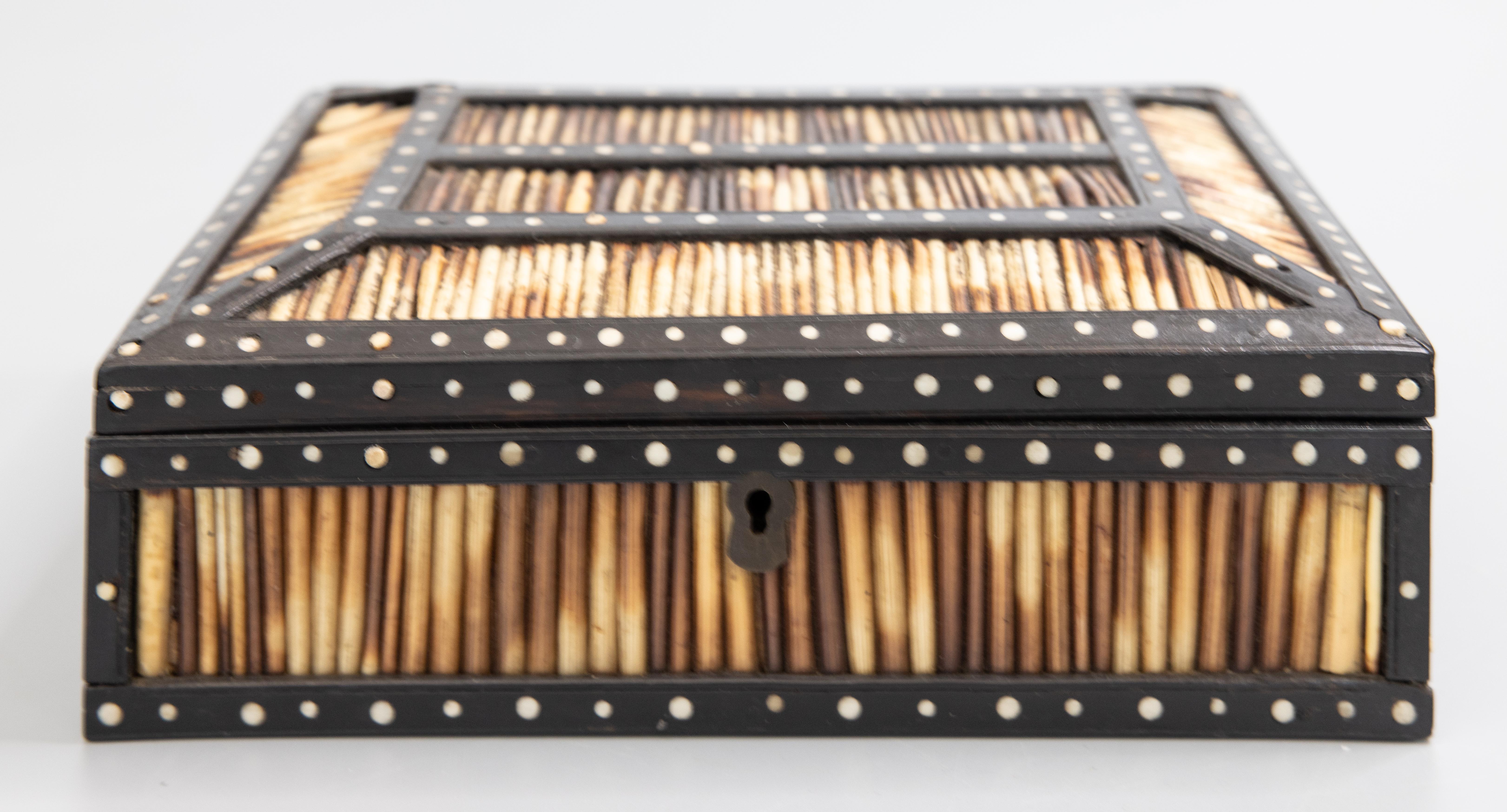 A fine antique 19th century British Colonial handcrafted porcupine quill and ebony box, made in Matara, Ceylon the colonial name for Sri Lanka. This fine box has a decorative raised lid, a hand carved elephant design on the interior, and is accented