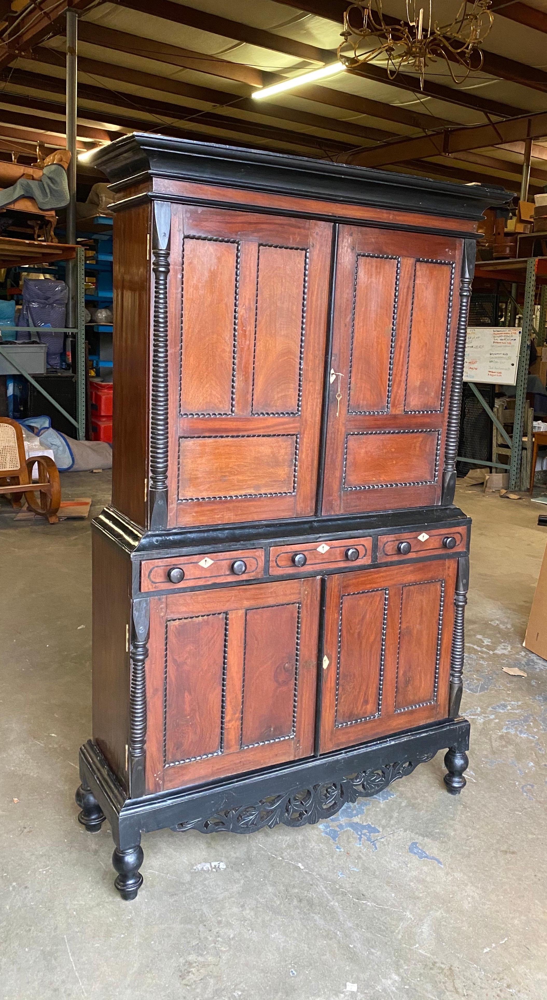 19th century Anglo-Indian jackwood and ebony cabinet. Dutch colonial era from Ceylon. Two part cabinet resting on ebonized base (3 parts).