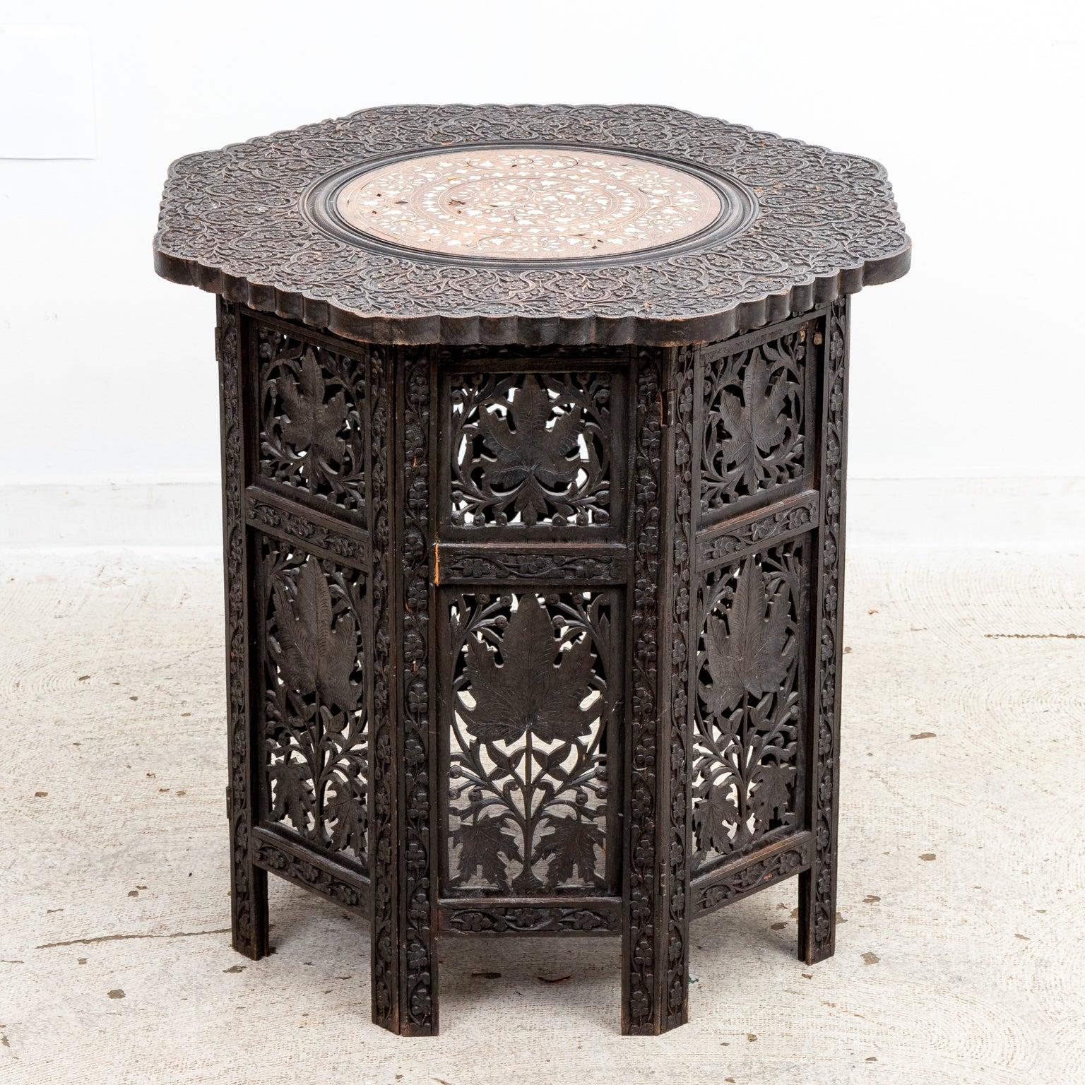 A good quality 19th century Anglo Indian octagonal form side table with 
intricately carved teak fretwork panels and top. A bone inlaid central 
medallion features floral sprays and a geometric border.
