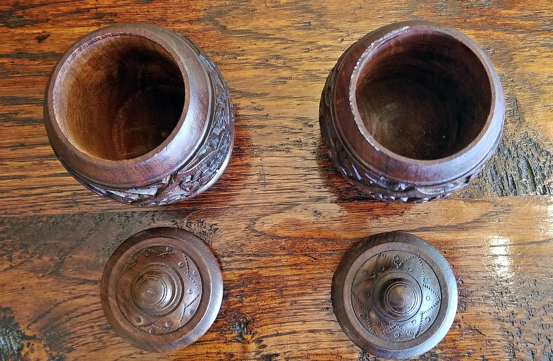 Nice pair of Anglo-Indian, hand-carved spice/tobacco jars.

19th century Anglo-Indian pair of carved wooden spice urns.

19th century, circa 1890 with beautiful floral carvings in rosewood.

History of spices: The spice trade developed