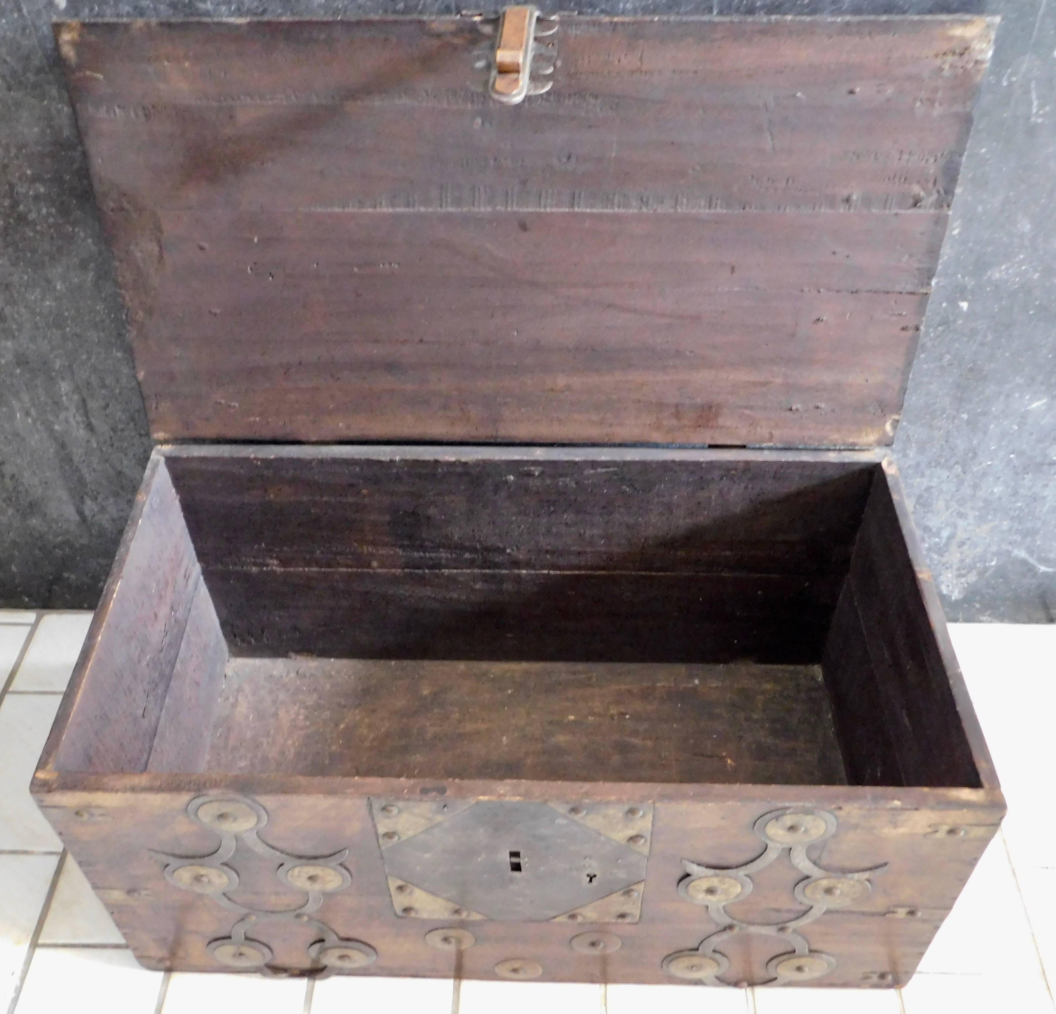 A robust Anglo Indian teak trunk with handmade brass and iron straps and mounts .
Used on ships for precious cargo to be shipped to Europe.
 