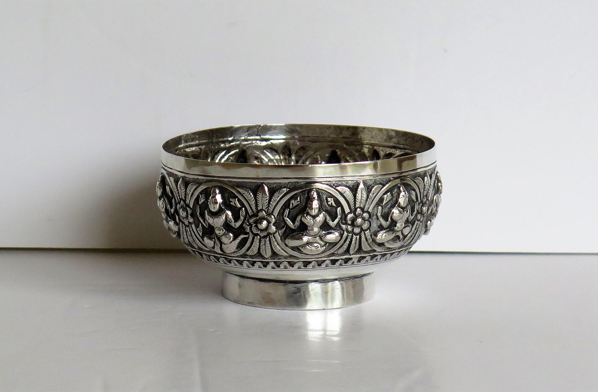 This is a solid silver Anglo-Indian bowl decorated with seated Dieties and made in India in the late 19th century, circa 1880.

The small circular bowl is made of solid silver and has a low foot.

The bowl has been beautifully hand chased with