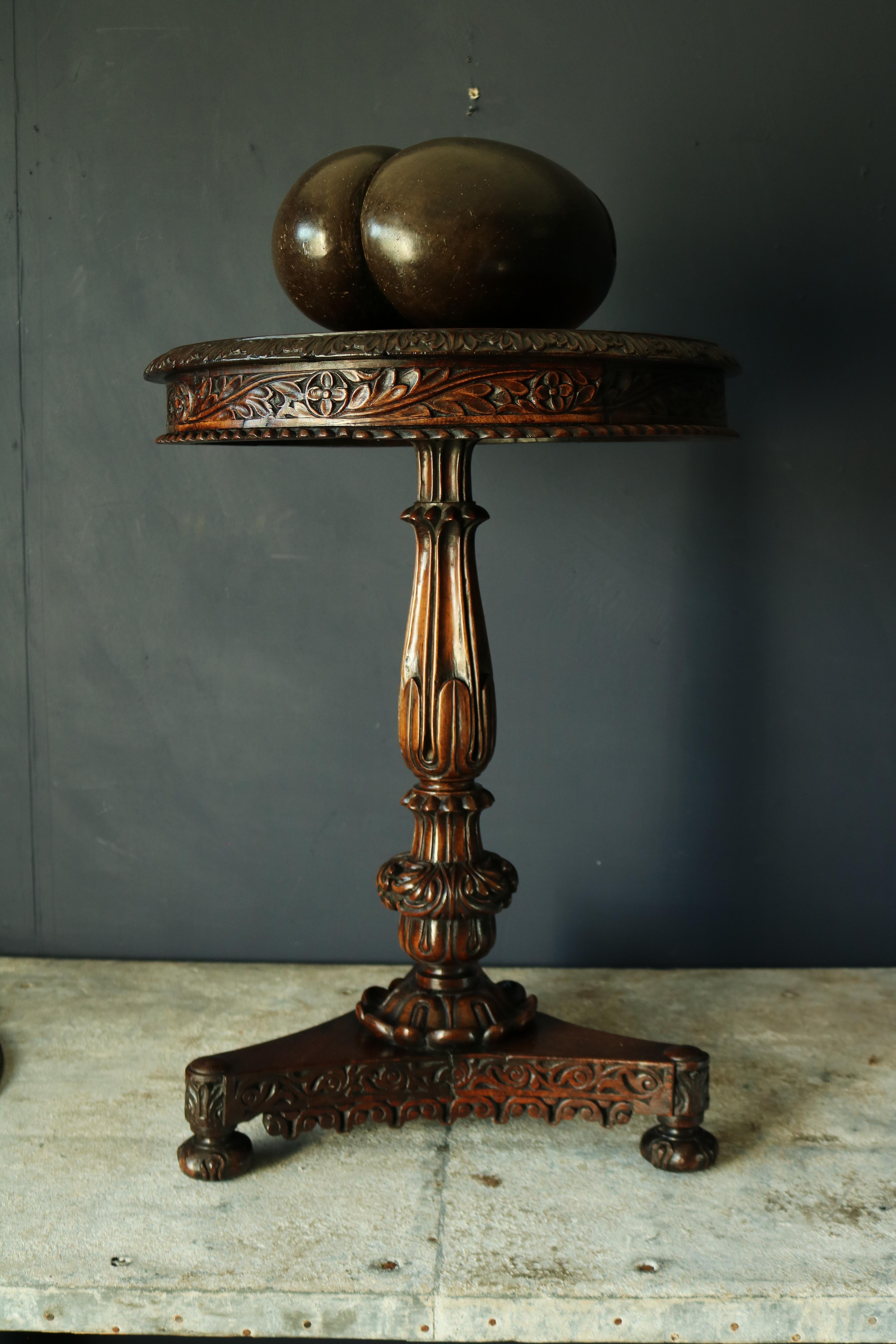 A 19th century Anglo-Indian tilt-top occasional table made from padauk wood, profusely carved in the Indian manner, beautiful colour and patina throughout.
  