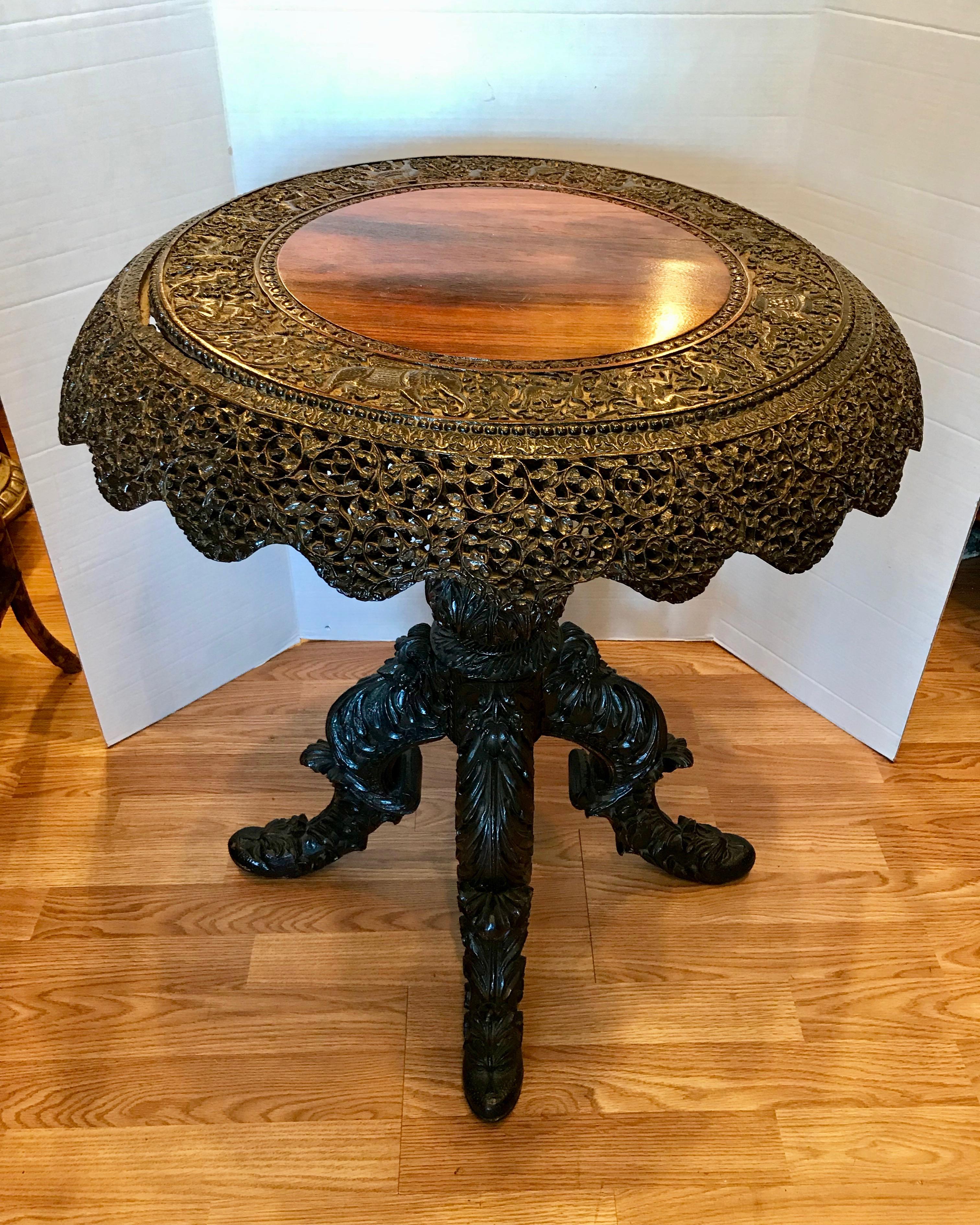 Richly, elaborately and profusely carved - the table is raised upon a 
