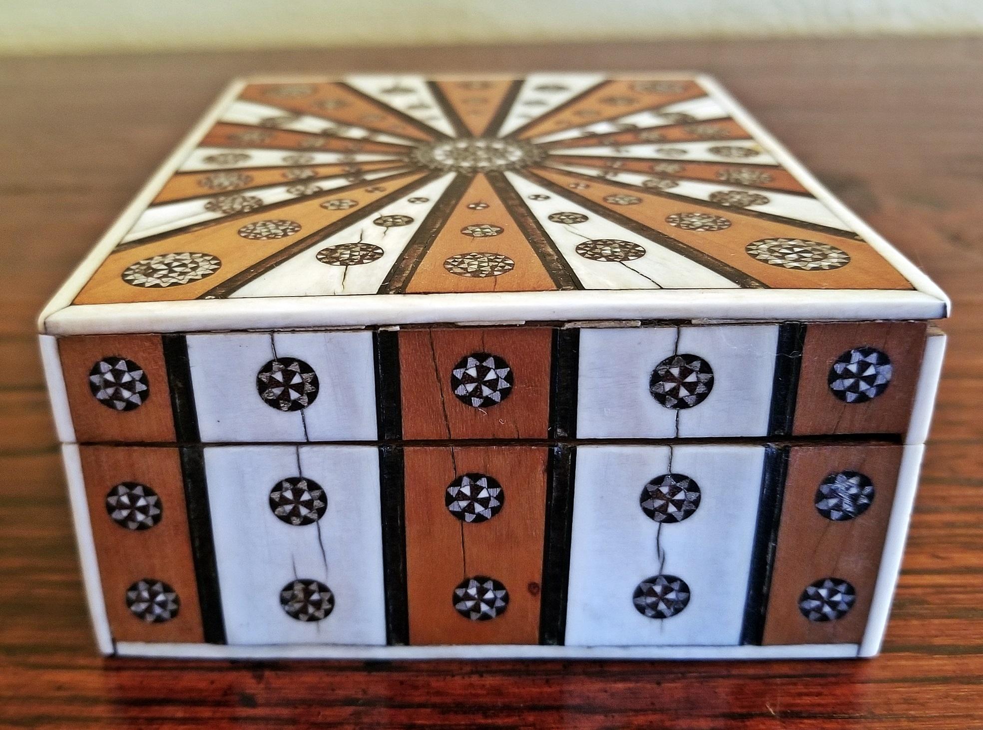 Gorgeous Anglo-Indian rectangular shaped trinket box in sunburst pattern.
Made in Vizagapatam, India in the 19th century, circa 1865.

The box is constructed of sandalwood the covered in bone/faux ivory and rosewood in alternating sections in a