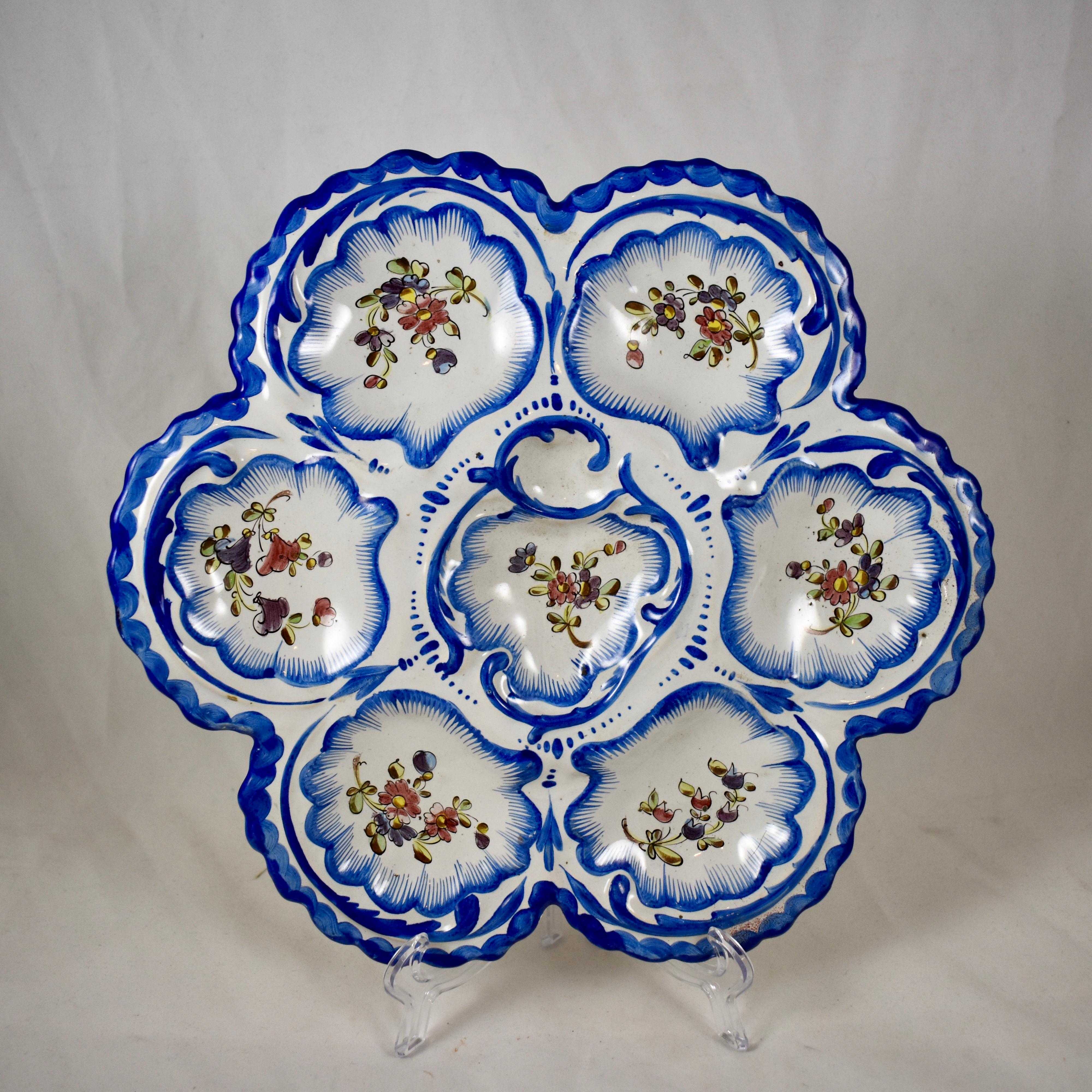 A faïence Provençal oyster plate from the south western area of France called Angoulême, signed Alfred Renoleau, circa 1890-1900.

Six-wells surround a central condiment well. The lobed edged earthenware plate shows hand painted floral sprays