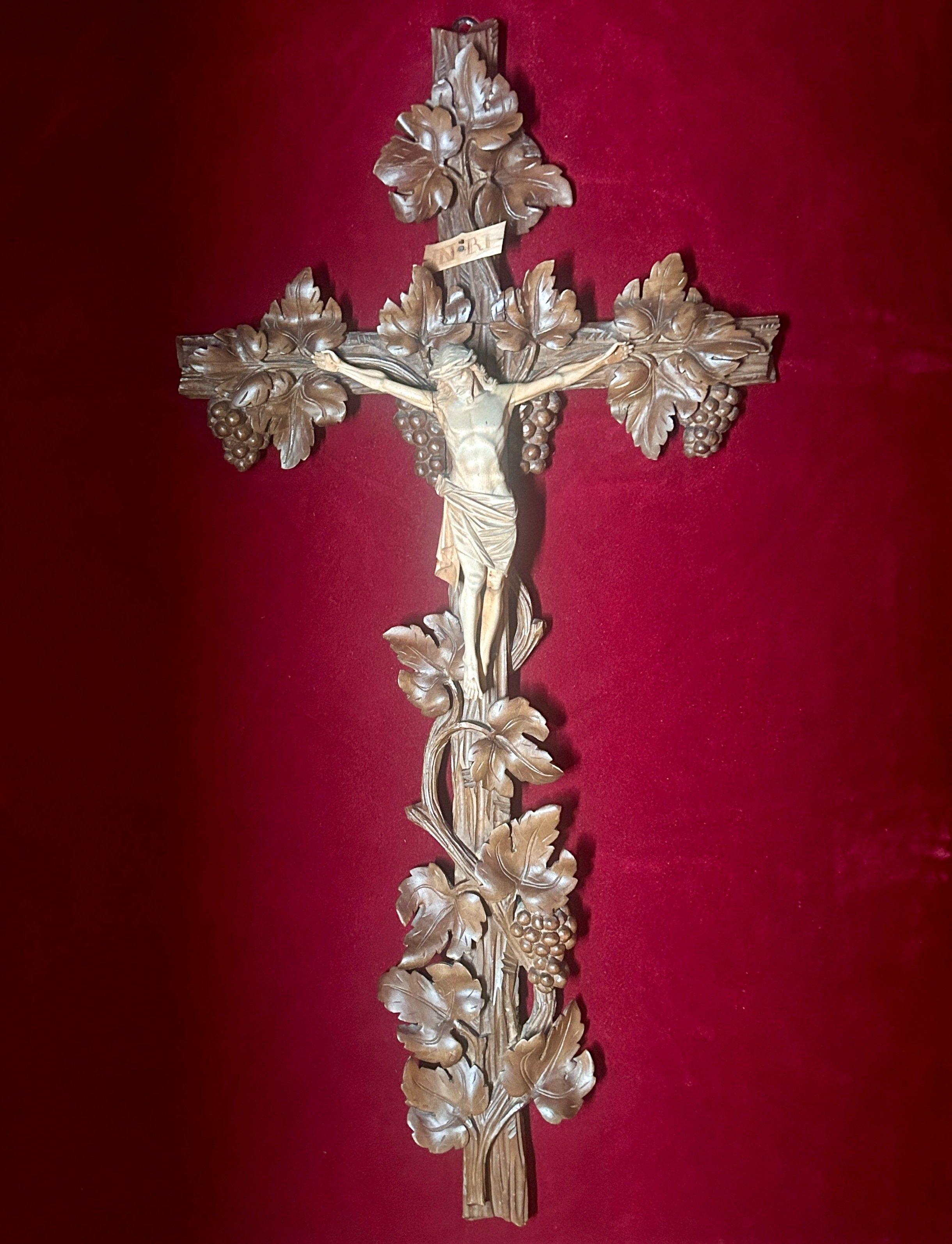 19th Century Black Forest Antique Wall Hanging Crucifix with Corpus Christi and Vine Leaves.

Large, unusual and elaborately hand carved wall hanging Black Forest crucifix with corpus christi, vine leaves & grapes C. 1890 - 1899.

Limewood & stained