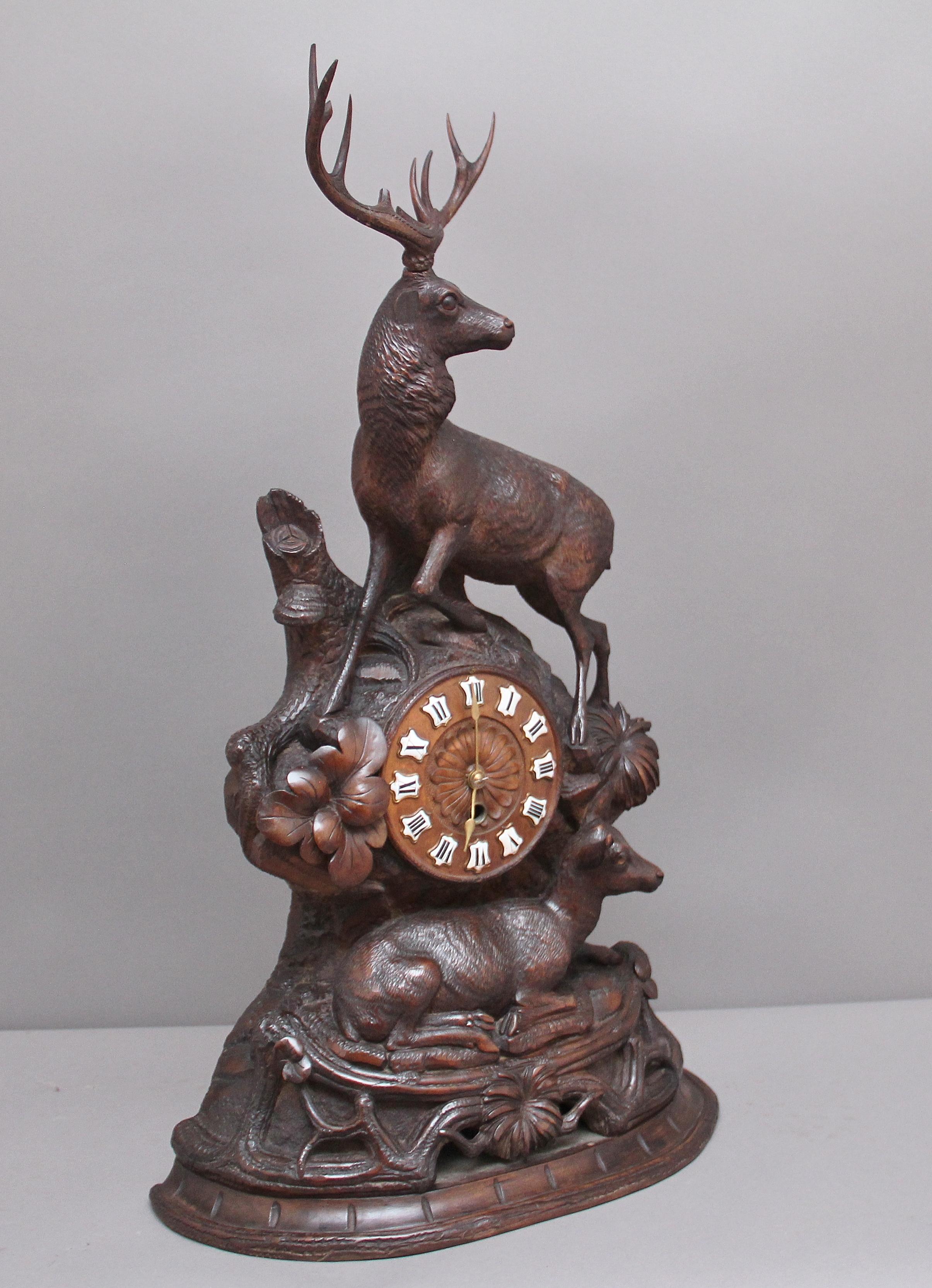 A superb quality 19th century walnut black forest mantle clock, the clock dial located at the centre within a rock face surrounded by various foliage with a hind below and stag above. Lovely crisp carving and in excellent condition, the movement has