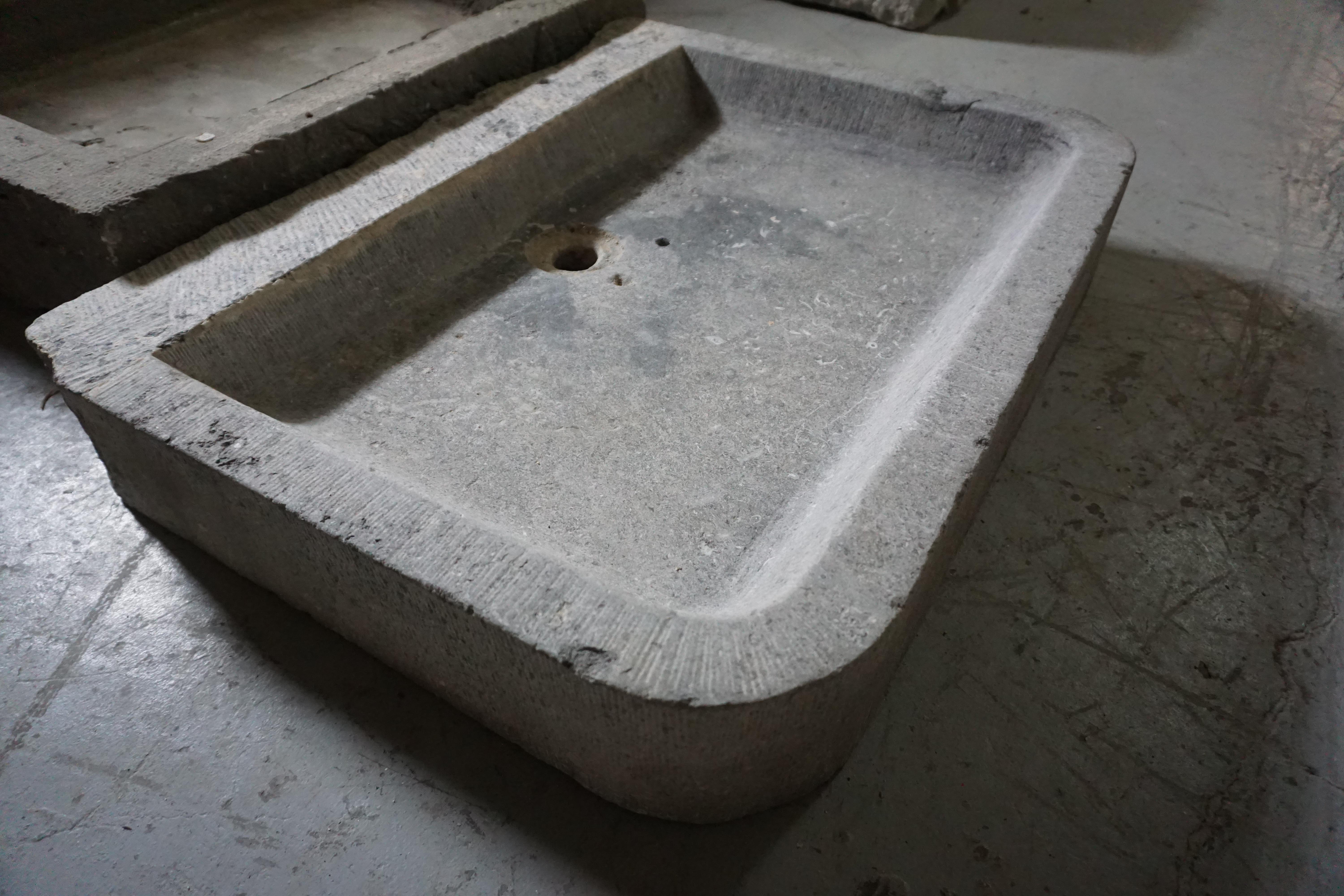 This bluestone sink originates from Belgium circa the 1820s. Features a center drain hole.

Measurements: 30.75'' W x 5.5'' H x 23.75'' D.