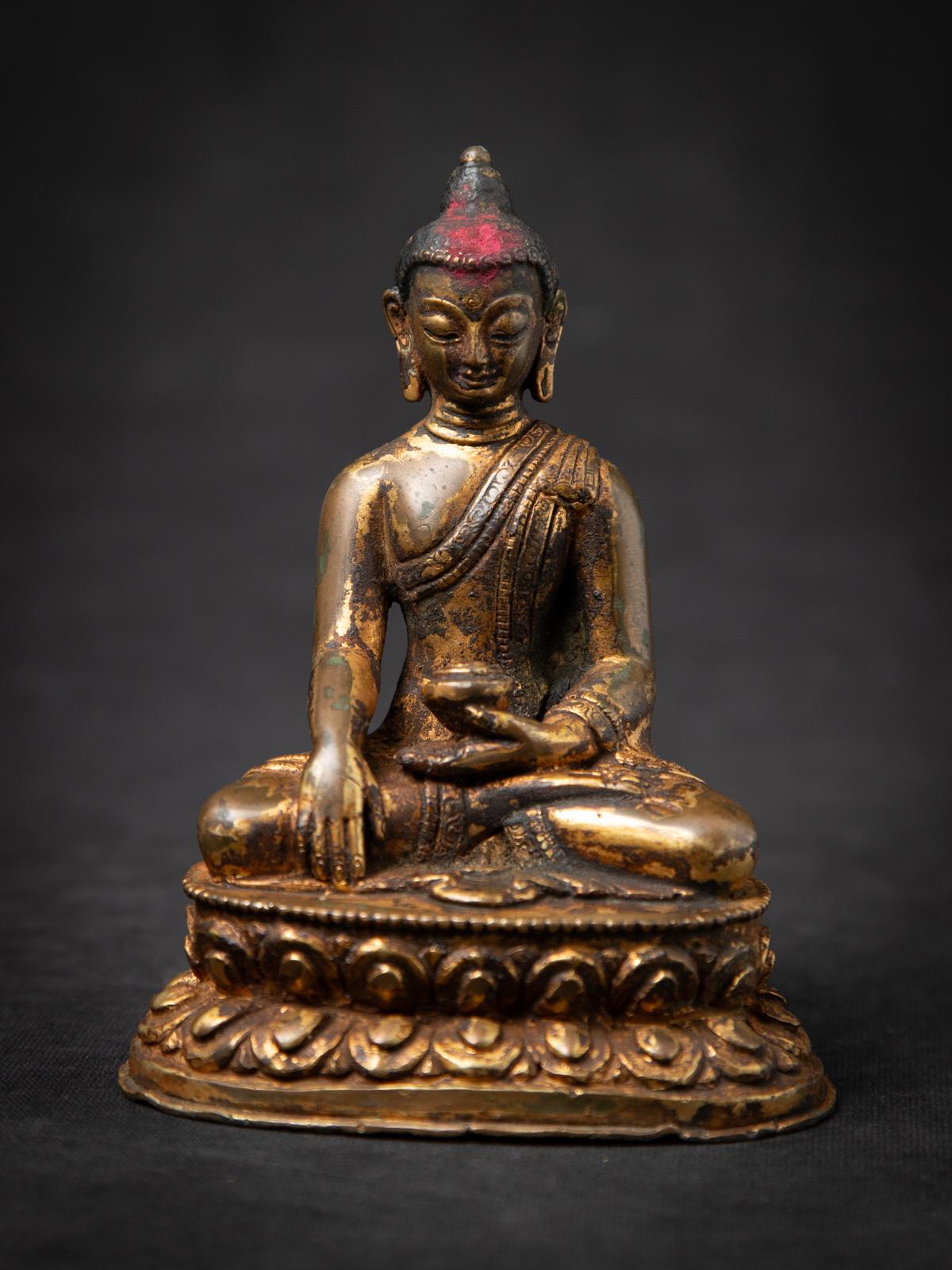 Discover this antique bronze Nepali Buddha statue, an authentic 19th-century piece that reflects Nepal’s rich Buddhist tradition. Crafted from solid bronze and fire gilded with 24 karat gold, it features the Bhumisparsha mudra, symbolizing the