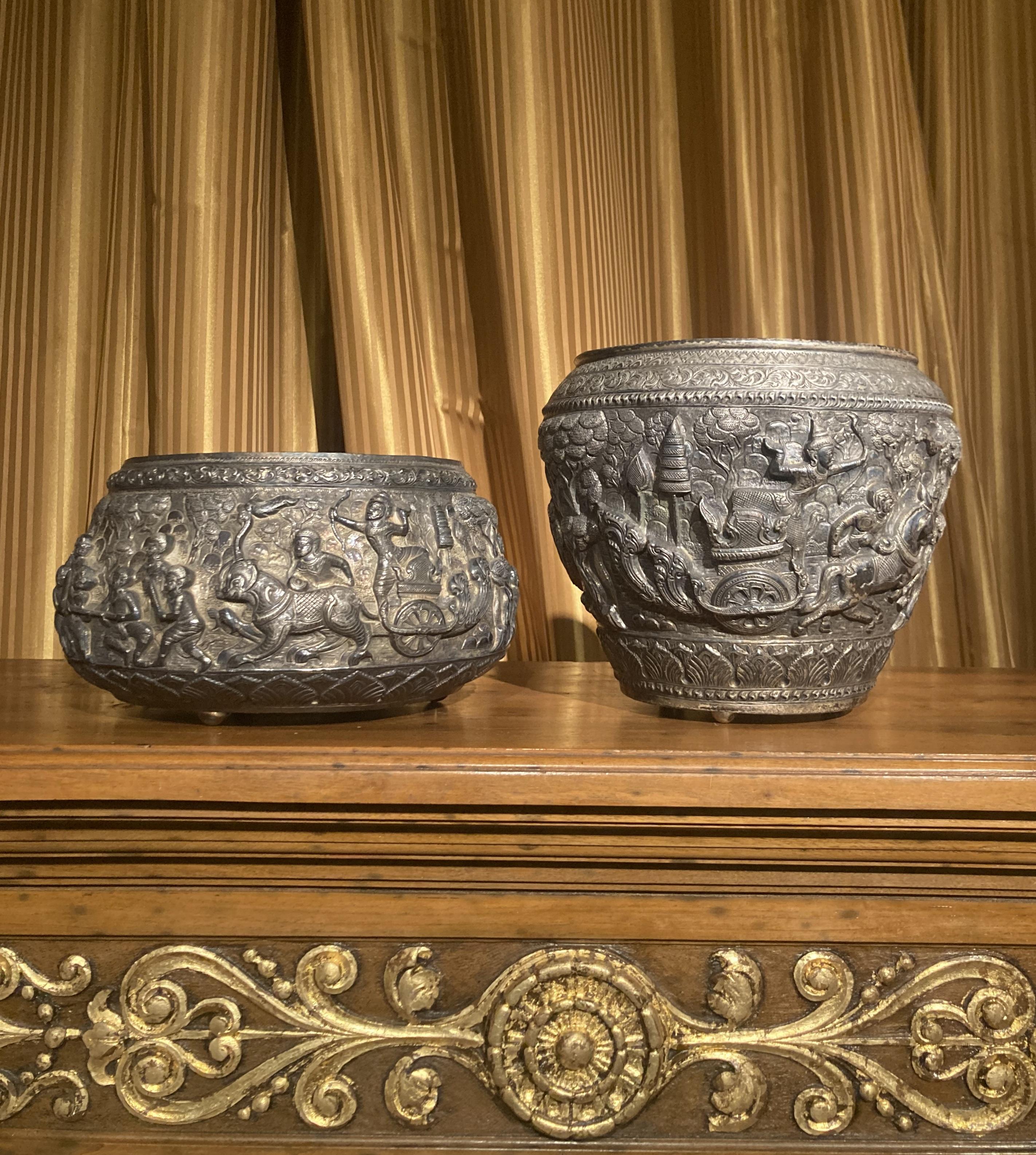 This is a sensational pair of 19th century antique Burmese silver repousse Thabeik bowls, both richly decorated in the round in high relief depicting different traditional scenes from the Burmese mythology and history, showing very detailed figures,