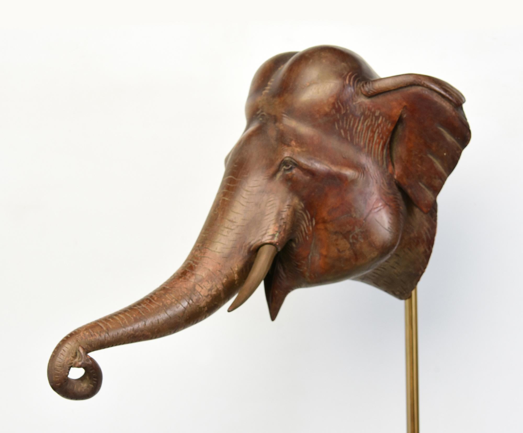 Antique Burmese wooden elephant head with stand.

Age: Burma, 19th Century
Size excluding stand: Length 46 C.M. / Width 29.3 C.M. / Height 29 C.M.
Height including stand: 88.2 C.M.
Condition: Nice condition overall (some expected degradation due to