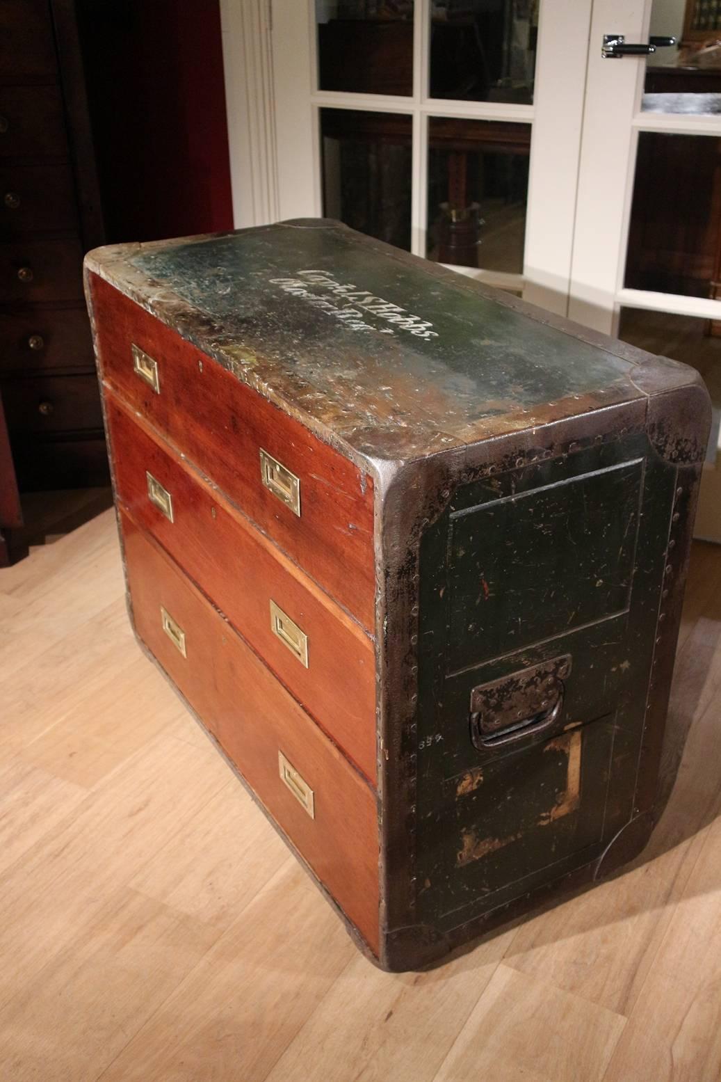 Very special antique campaign chest of drawers from England. The case has a casket externally with metal bands against damage and heavy carrying handles. Originally, such a plate was also on the front. This plate was secured with screws for