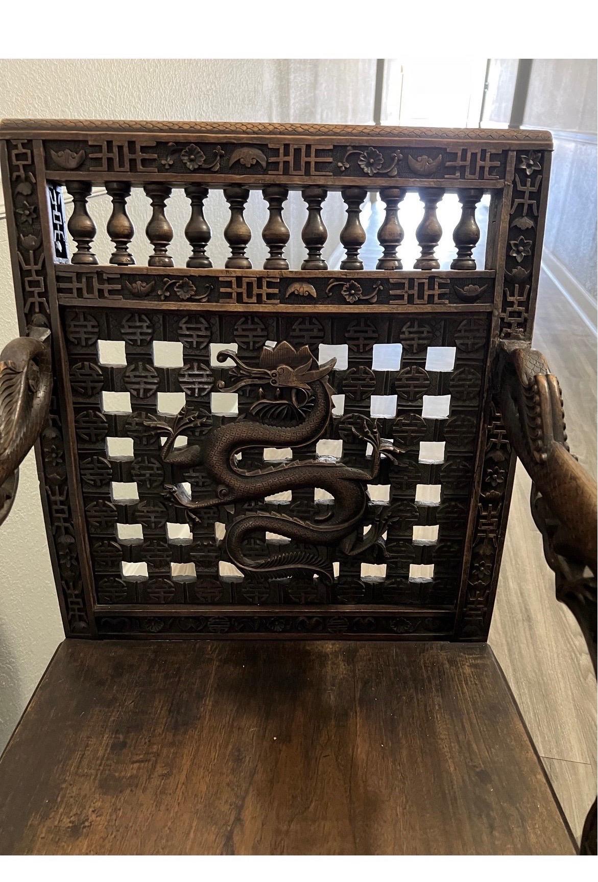 A pair of antique chinese armchairs with absolutely exceptional carvings. Dragons all over, chinese symbols of longevity and happiness, the back as ornate as the front - these chairs are like no other!