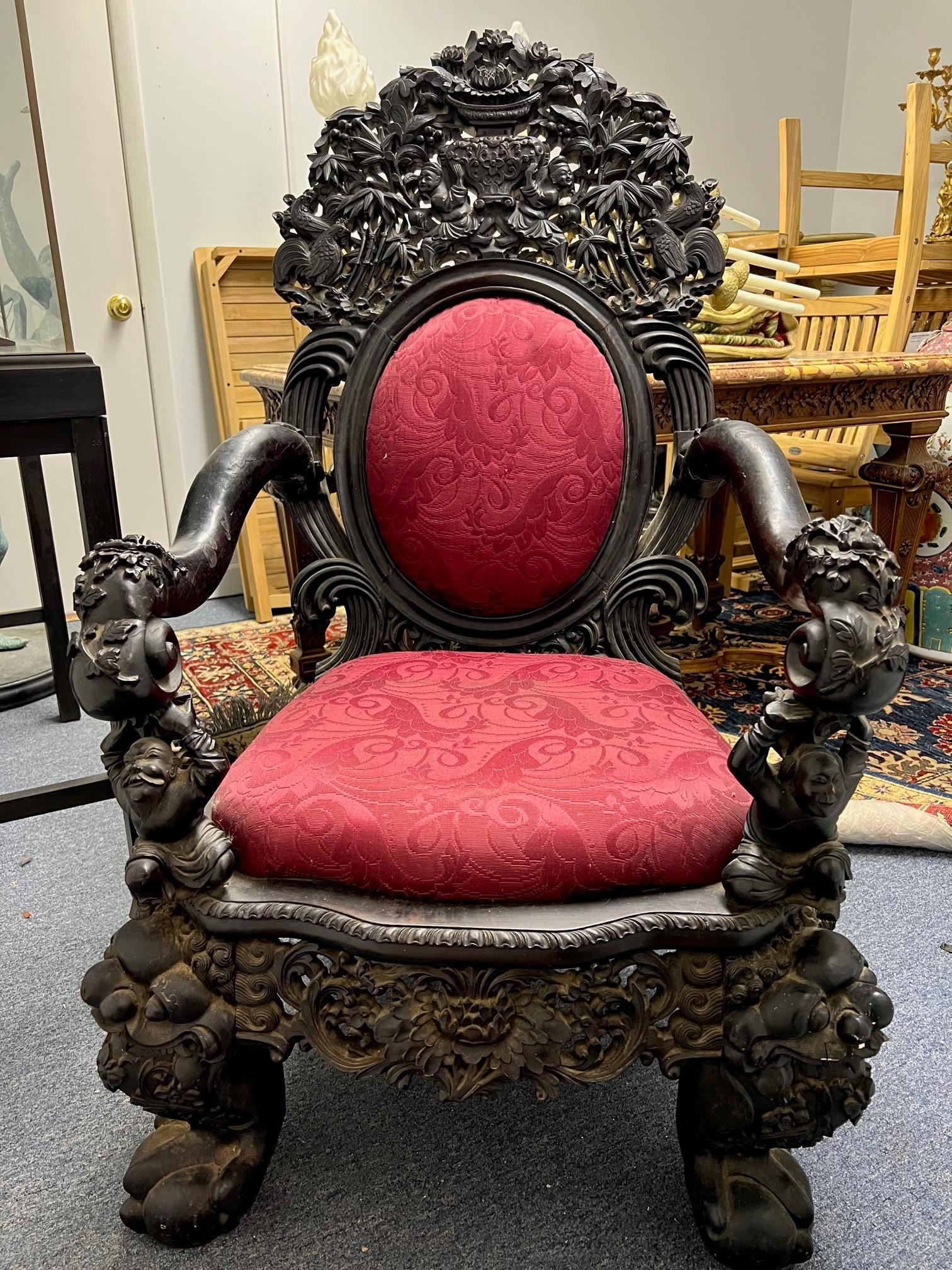 Late 19th century antique very decorative carved throne chair with amazing details. This antique  carved throne chair is full of carvings with Asian men, bamboo trees, flowers, roosters and other birds. The carvings are in good condition but the