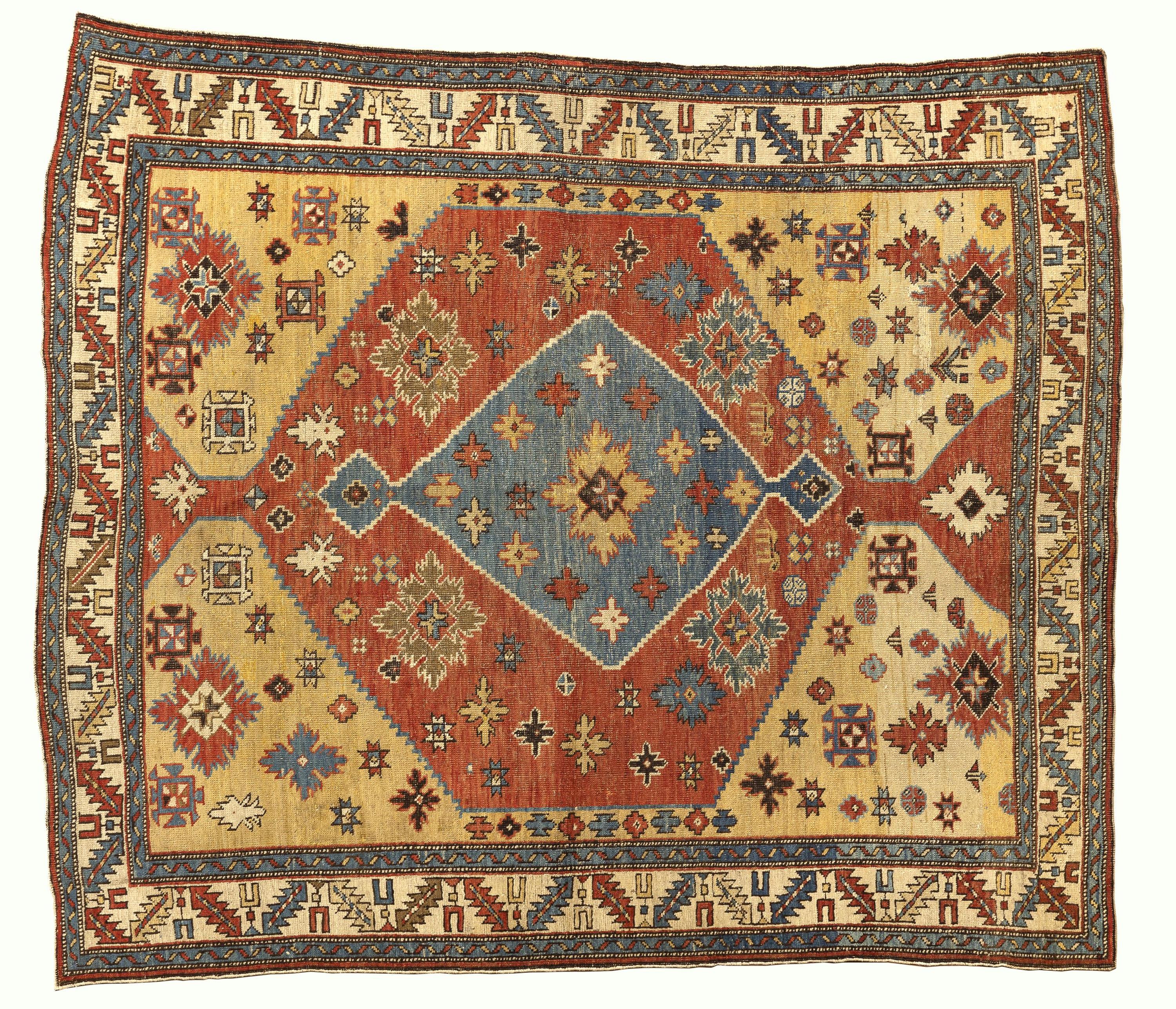 This 19th-century Caucasian Shirvan rug presents a striking balance of geometry, color, and artisanal character. Its central diamond medallion—woven in a luminous combination of soft blues, warm reds, and golden tones—anchors the design with an