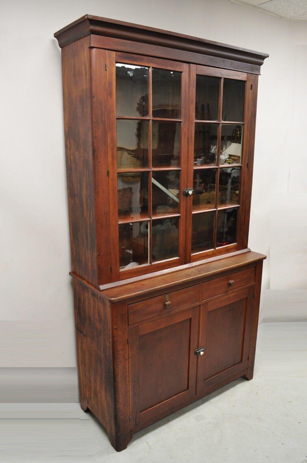 19th century Antique cherry wood cupboard hutch China cabinet with wavy glass. Item features original wavy glass panes, warm aged patina, solid wood construction, beautiful wood grain, 2 part construction, 4 swing doors, no key but unlocked, 2