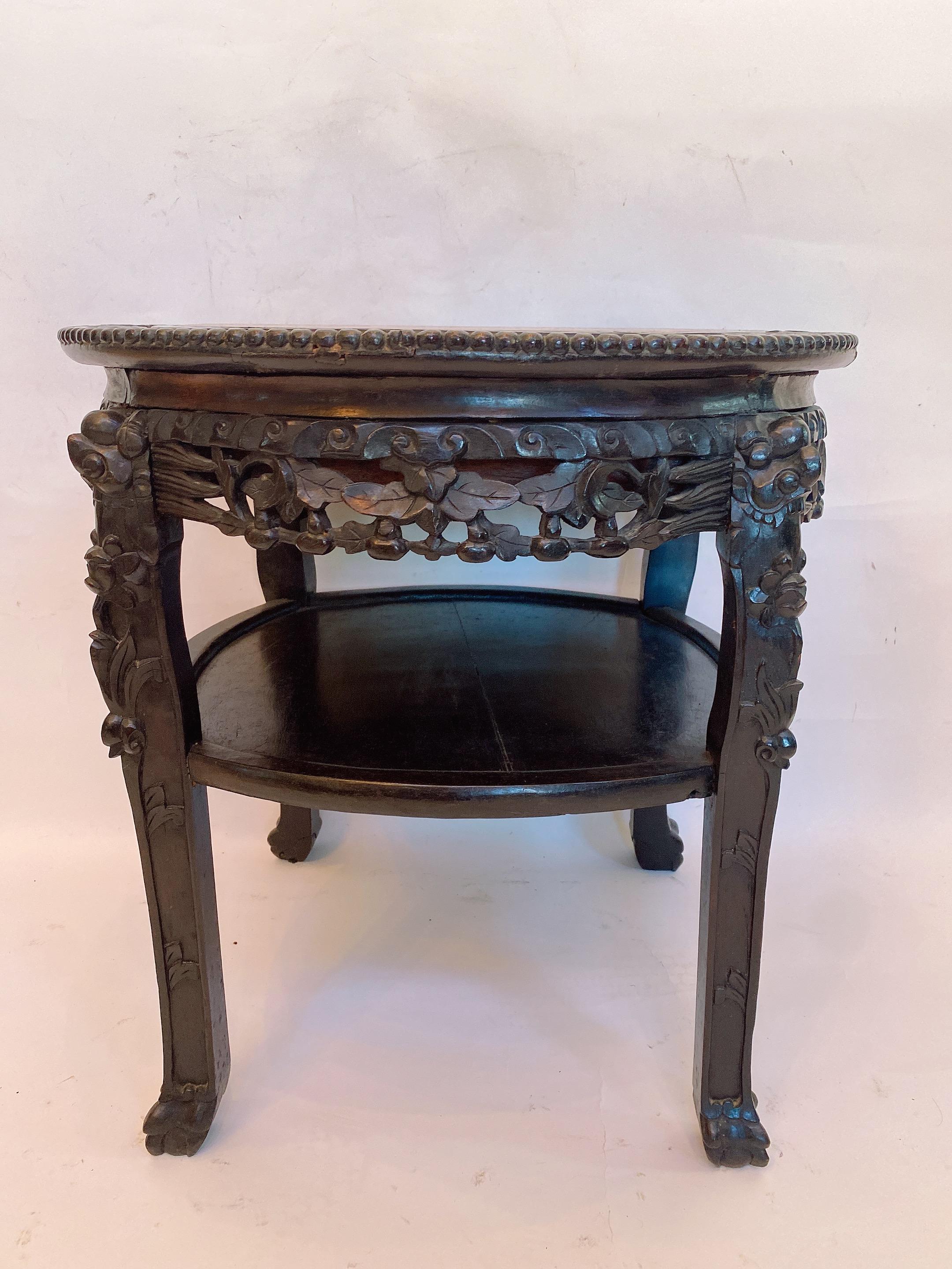 A 19th century antique Chinese heavily carved hardwood circular two tiered tables with rouge marble top insert, the inset marble top over carved rosewood apron with dogwood design and dragon shoulders, see more pictures, measures: 23.5