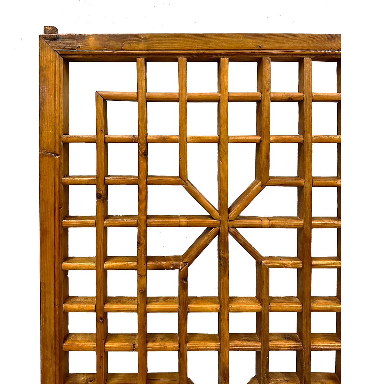 This Chinese Qing Dynasty period large carved elm wood interior window panel from the late 19th century, with fretwork design, Created in China during the Qing Dynasty in the later years of the 19th century, of this architectural interior window
