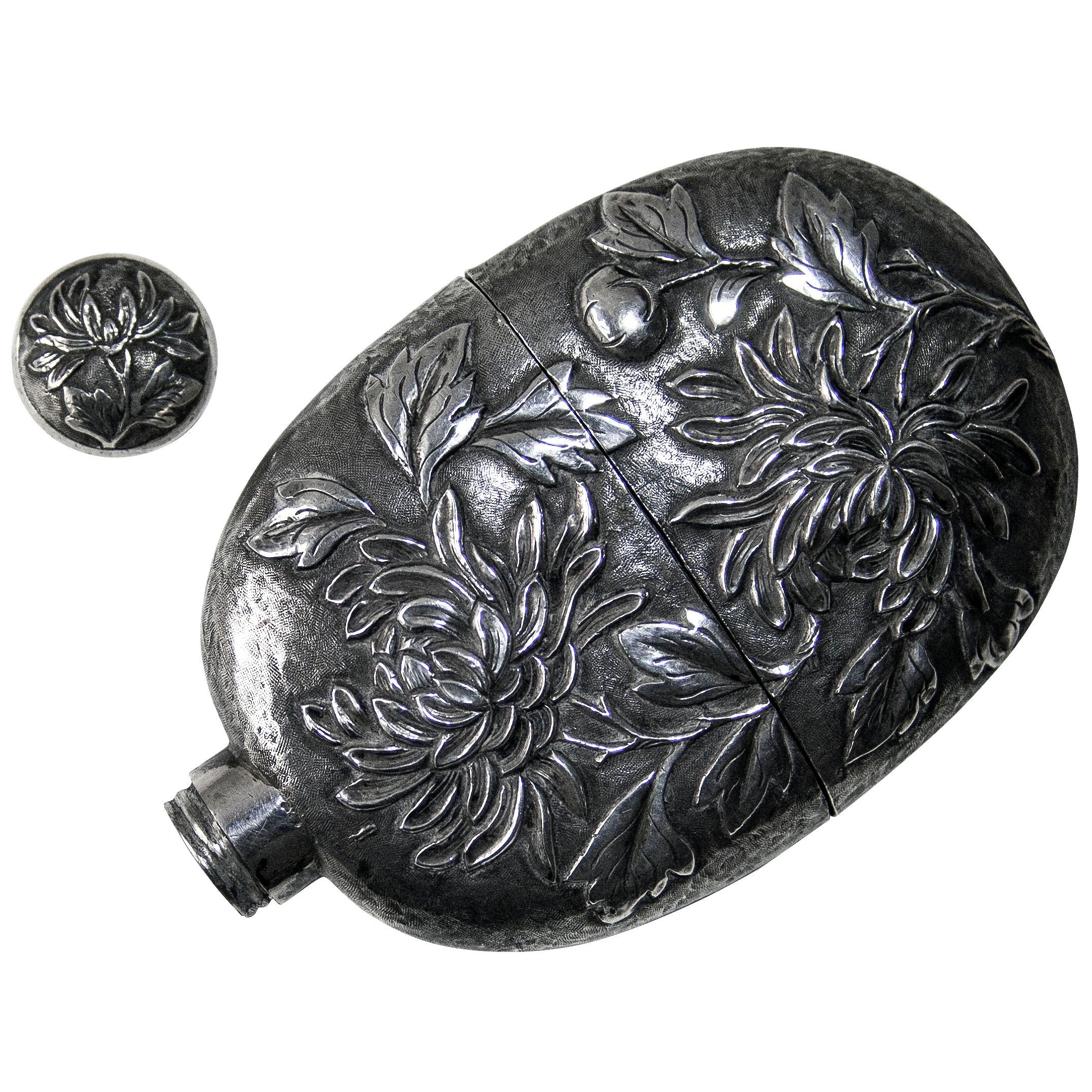 A superb quality Chinese export silver spirit drinking flask with pull-off drinking cup and screw-top stopper. The body of the flask, cup and screw-top are all hand-chased and raised in the Chrysanthemum design.