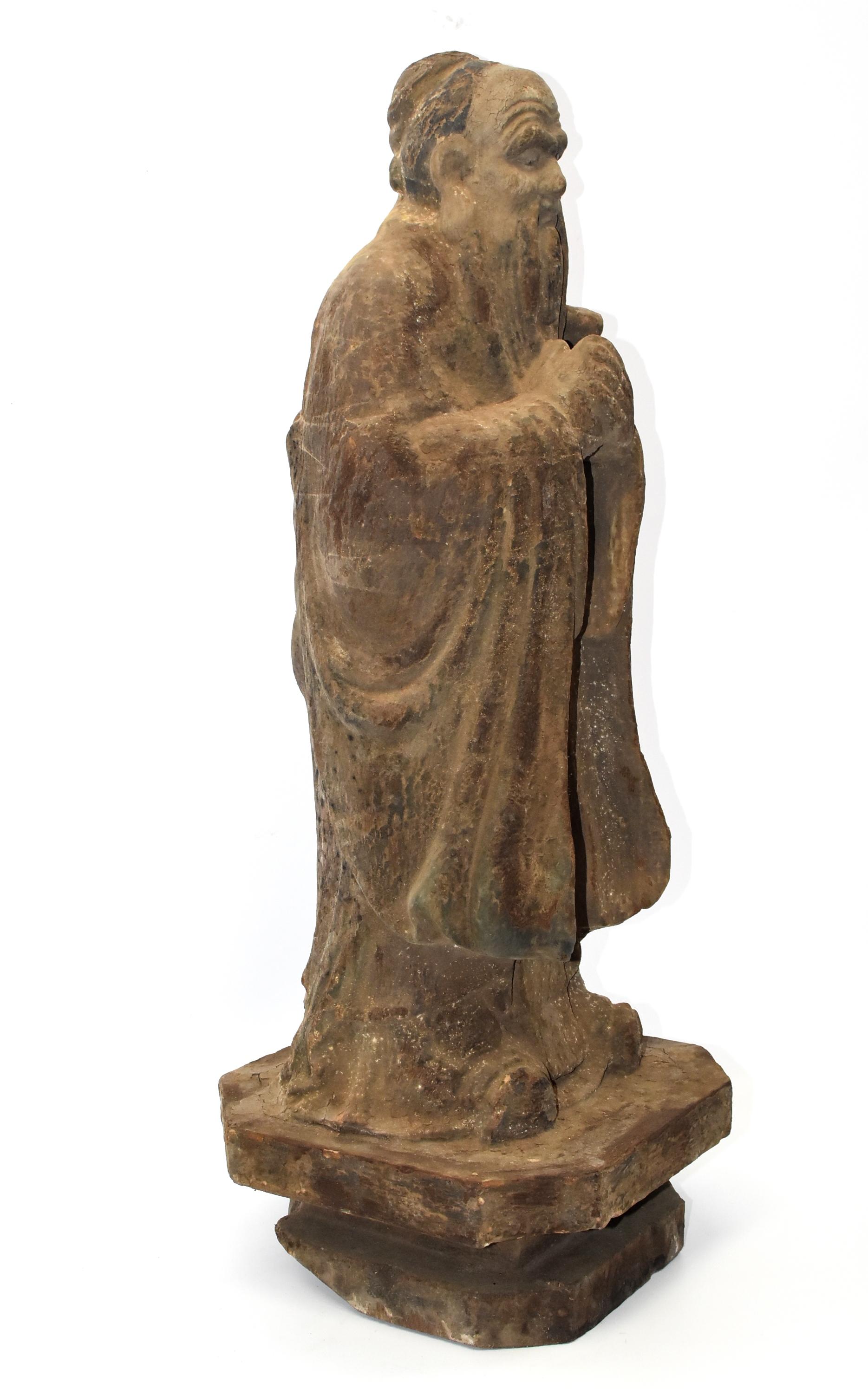 This is a wood sculpture featuring China's most respected philosopher, the founder of Taoism, Mo Zi, who lived in Warrior State Era, 476-390 BC. He was a well-known scientist, educator, and military strategist. His beliefs are centered in governing