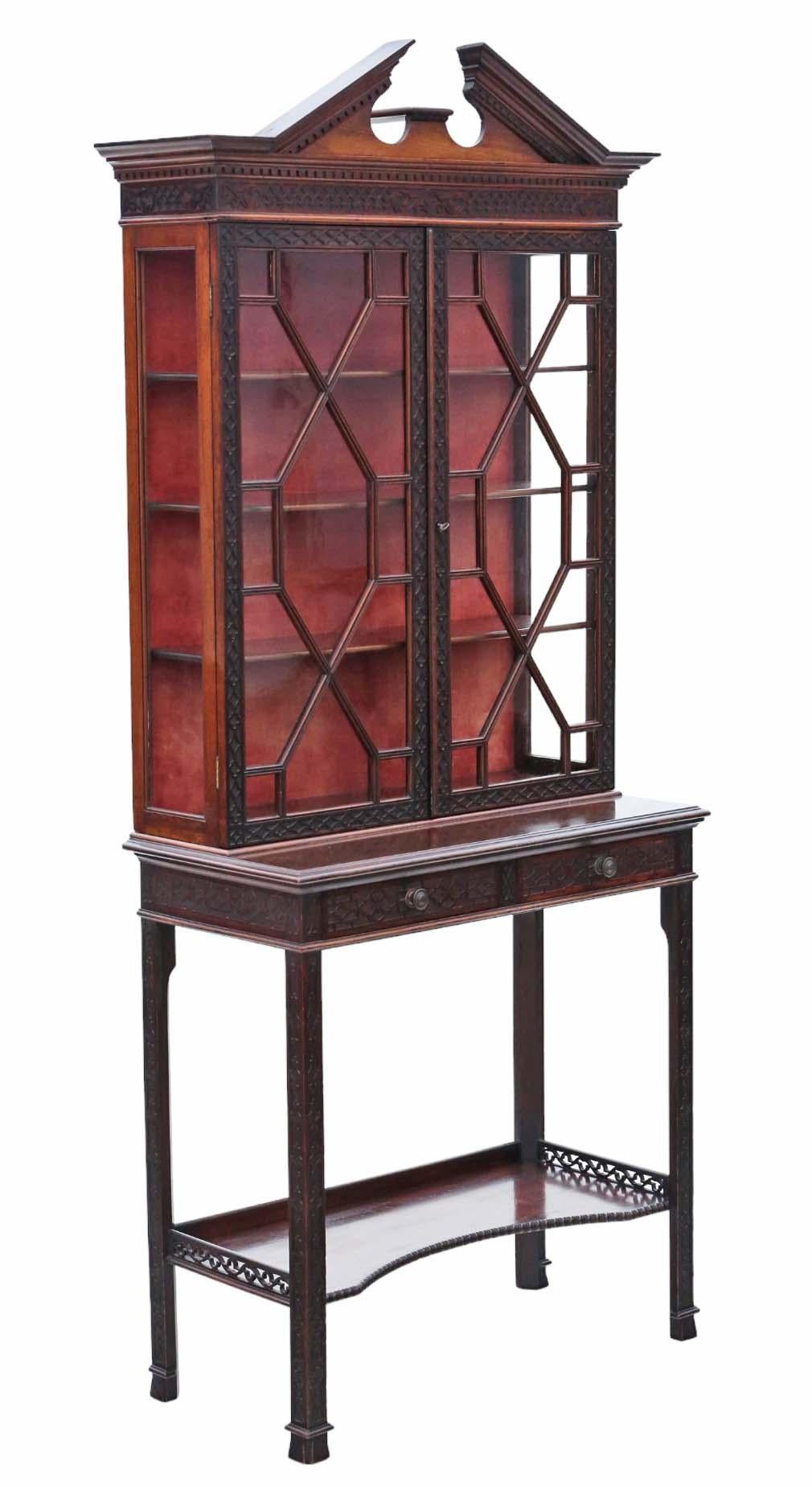 Ti presentiamo un'elegante vetrinetta in mogano antico del XIX secolo realizzata dalla stimata ditta Edward & Roberts. Questo pezzo eccezionale presenta un'intricata decorazione a traforo cieca Chinoiserie e un frontone ad arco spezzato che ne