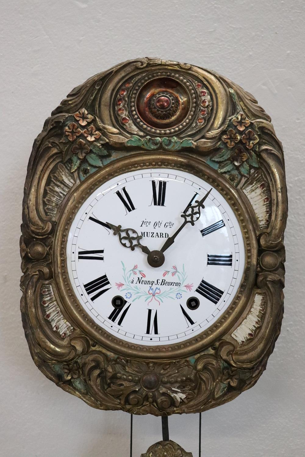 Rare antique French wall clock from the 19th century. Made of finely embossed and painted bronze. Working clock. Installation is not included in the delivery.
 