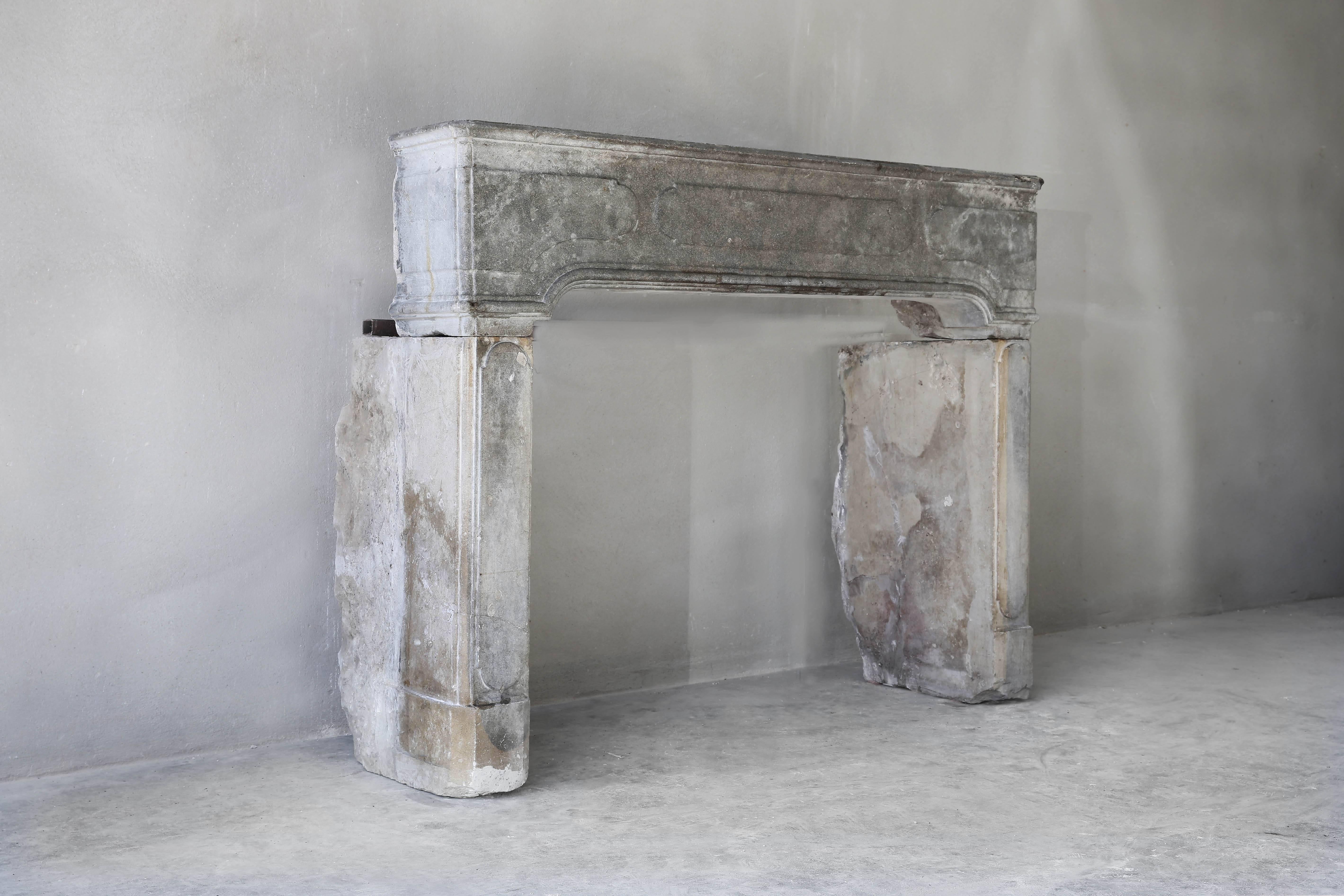 This beautiful antique grey fireplace of marble stone comes from the place Dole in France! A special and exclusive type of marble that is very hard to fabricate! A beautiful fireplace in terms of size and finish. The front section is equipped with a