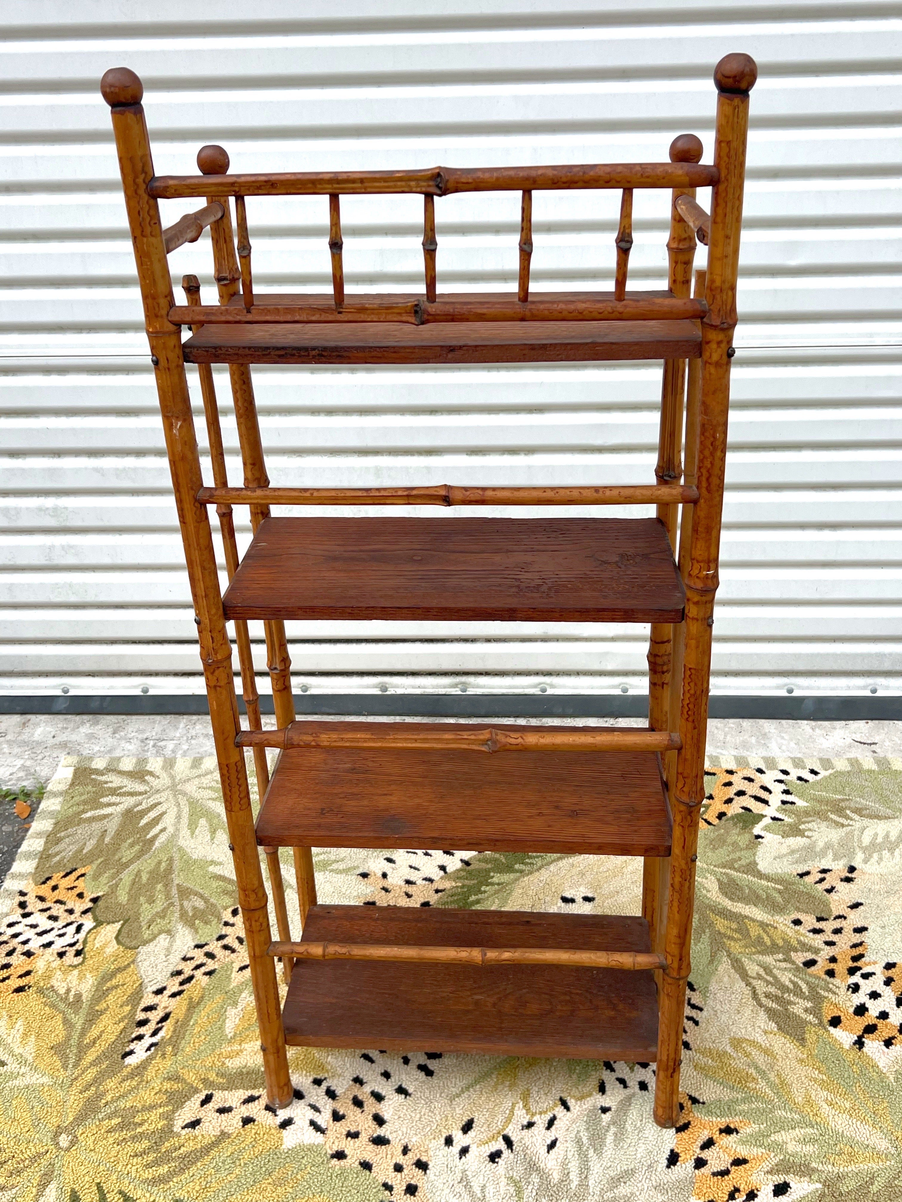 Antique bamboo etagere shelf stand. The Victorian era stand features a bamboo frame with four wood shelves.
Around late 19th century to early 20th century