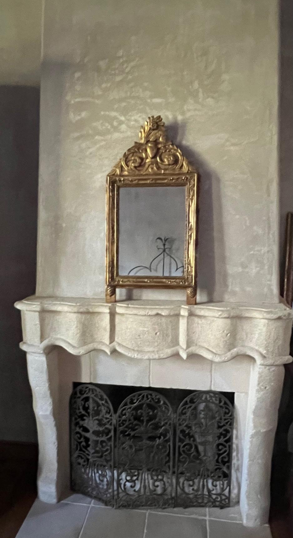 Antique French bridal mirror, hand carved wood top with a design of leaves, flowers and a heart in the center. The glass is antique as well as the frame and shows some discoloration and spotting indicative of mercury glass.