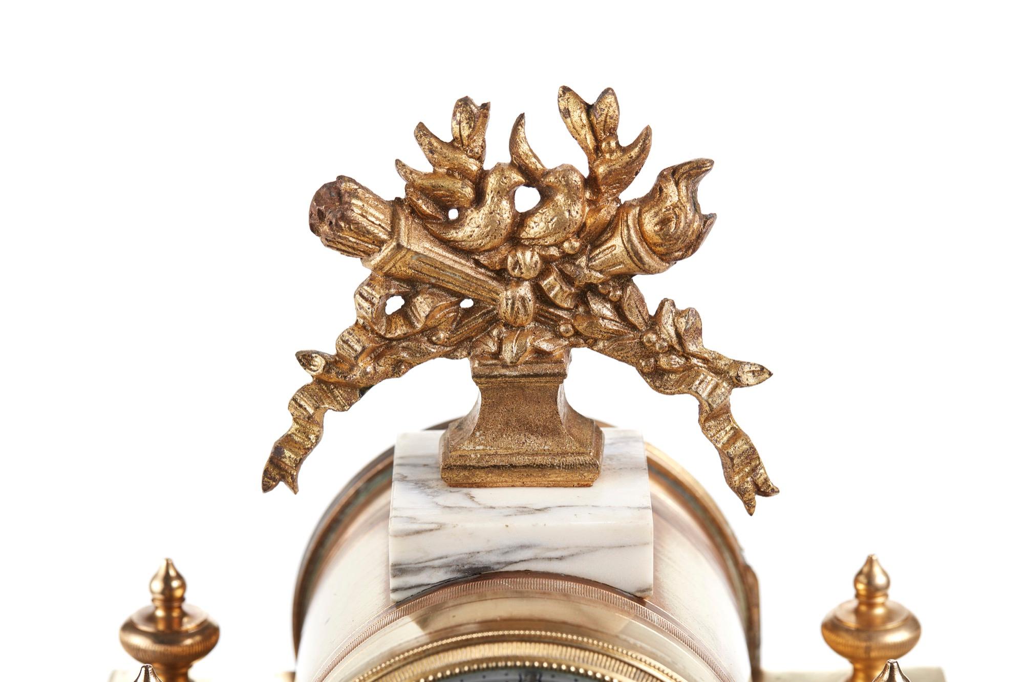 19th century French antique gilt brass and white marble mantle clock. Floral decorated enamel dial with twin train movement and sun-mask pendulum. Perfect working order and lovely overall condition, circa 1870.