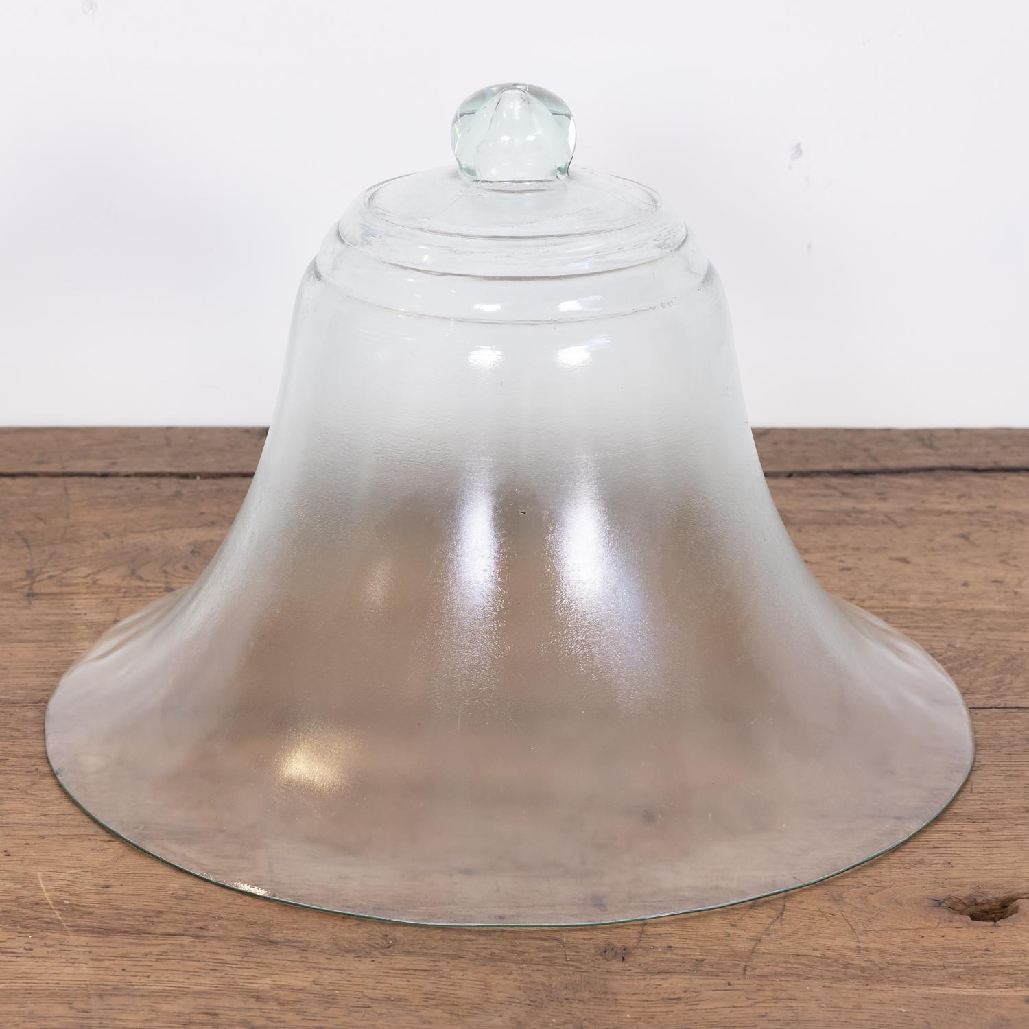 Large 19th century antique French bell shaped garden cloche formed as a single piece of clear glass with a solid knob handle, circa 1880s. Hand-blown from thick glass, it was designed to act as a small green house for lettuces and melons in the