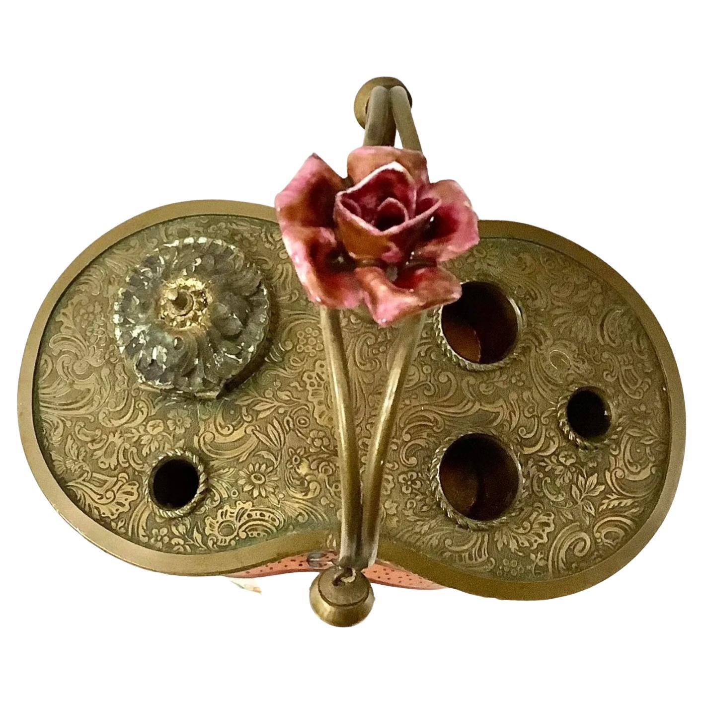 Beautiful Antique 19th century painted and gilded brass inkwell. Floral motif with pink rose on handle. 'Made in France' on underside.

 