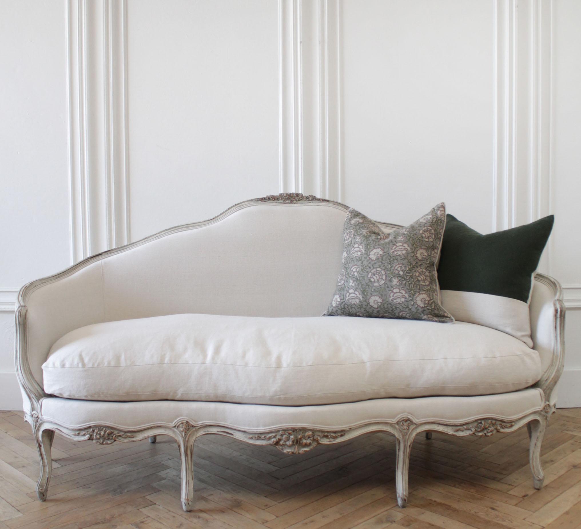 19th century antique French Louis XV style sofa
Painted in a light oyster white, with subtle distressed edges, and finished in an oyster antique glazed patina.
Upholstered in 100% pure organic Libeco linen in light natural. A large overstuffed