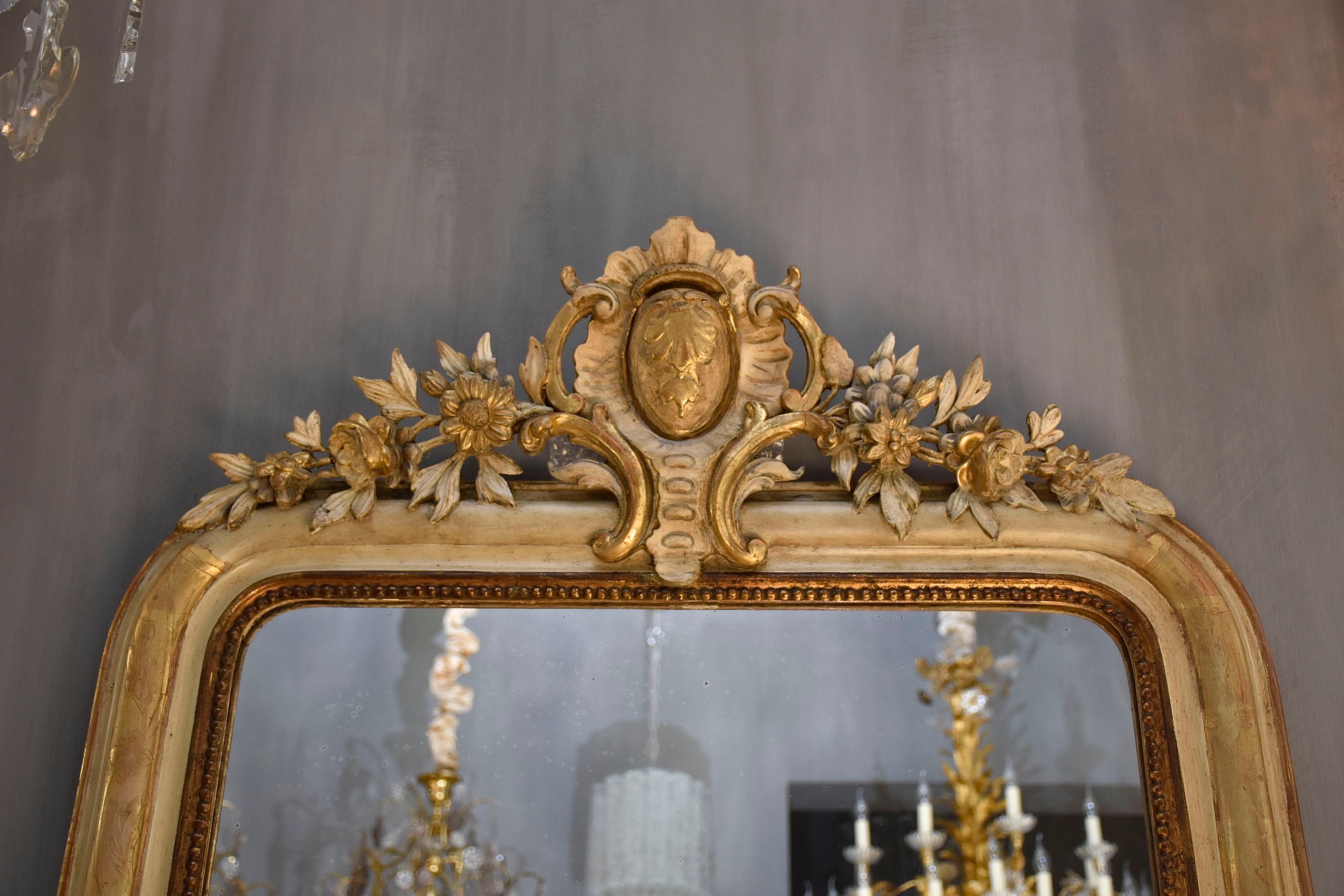 Gold Leaf 19th century antique French mirror with a crest For Sale