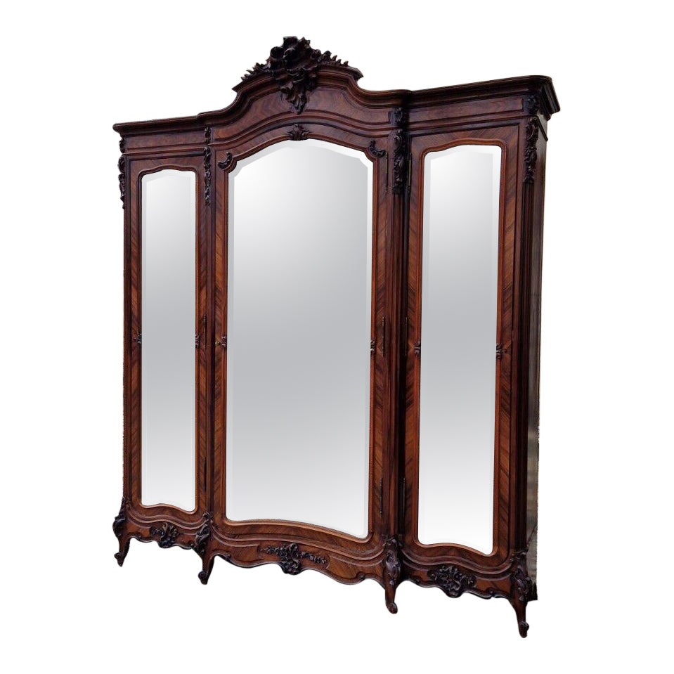 Marvellous Chateau Armoire

Antique Wardrobe Rococo Louis XV Triple Door Armoire

Fantastic Piece of French Furniture

Central Shell Crest (small top piece missing)

5 Shelves in all compartments

Drawer with key

Bevelled Mirror Doors

Door Keys (1